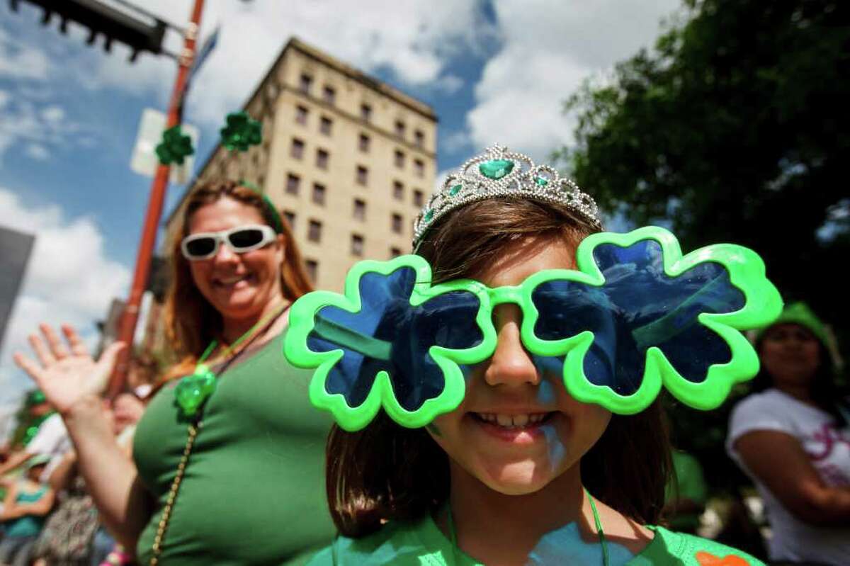 Molly Molina, 7, wears a pair of sunglasses as her mother, Crystal Manley, looks on.
