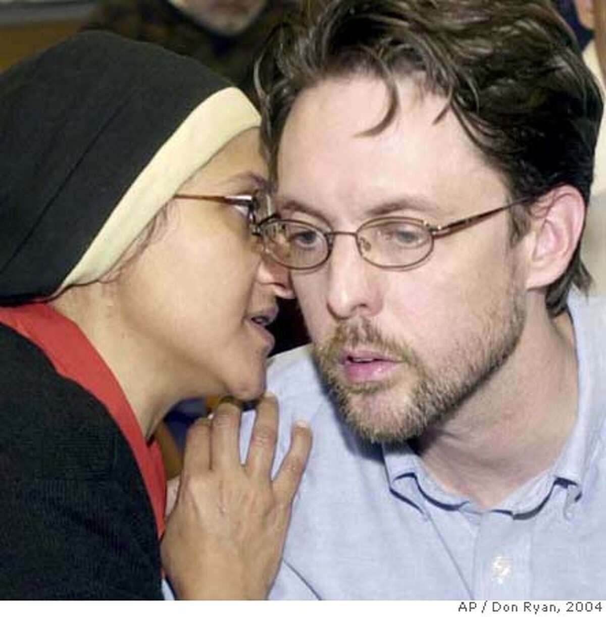 ** FILE ** Portland attorney Brandon Mayfield, right, confers with his wife, Mona Mayfield, during an announcement in Portland, Ore., in this May 24, 2004, file photo, that a federal judge dismissed the case against Mayfield in which he had been arrested in the Madrid train bombings investigation. U.S. District Judge Ann Aiken ruled in Eugene, Ore., Wednesday, Sept. 26, 2007, that the Foreign Intelligence Surveillance Act, as amended by the Patriot Act, "now permits the executive branch of government to conduct surveillance and searches of American citizens without satisfying the probable cause requirement of the Fourth Amendment." Mayfield had sued the federal government after he was mistakenly linked to the 2004 Madrid train bombings. (AP Photo/Don Ryan)