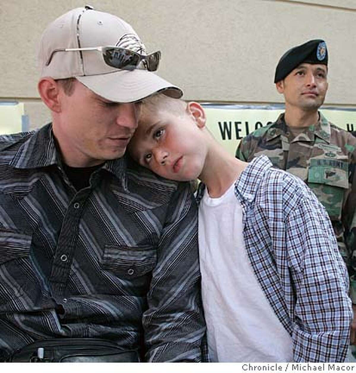 Justin Buyas, Michael's oldest son, rests his head on his dad's shoulder as he returned to his home in Eastern Washington. A heroes welcome at the local airport, included soldiers from Fort Lewis, the home base that Michael was staioned at, there to greet him upon his return. Story of American soldier Michael Buyas who lost both of his legs in an explosion while on serving in Iraq. He returns home for the first time since the incident took place last December, to his home town of Chelan, Washington, after spending the last 6 months at Walter Reed Hospital, recovering from his injuries, in Washington DC. 5/22/05 Chelan, Wa Michael Macor / San Francisco Chronicle