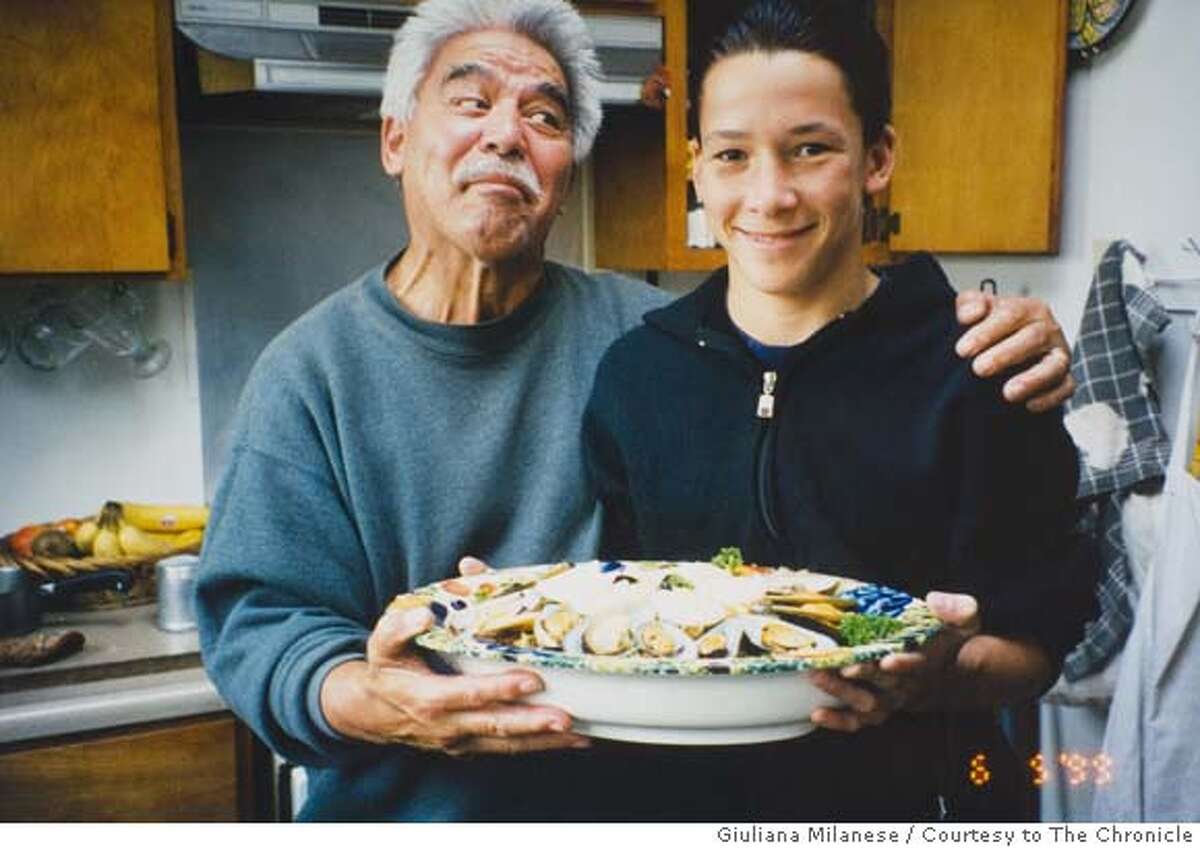Bill Sorro and his grandson, Rico Sorro, hold a plate of food they're about to serve in the kitchen of Sorro's Bernal Heights home in 1997. Giuliana Milanese / Courtesy to The Chronicle MANDATORY CREDIT FOR PHOTOG AND SAN FRANCISCO CHRONICLE/NO SALES-MAGS OUT