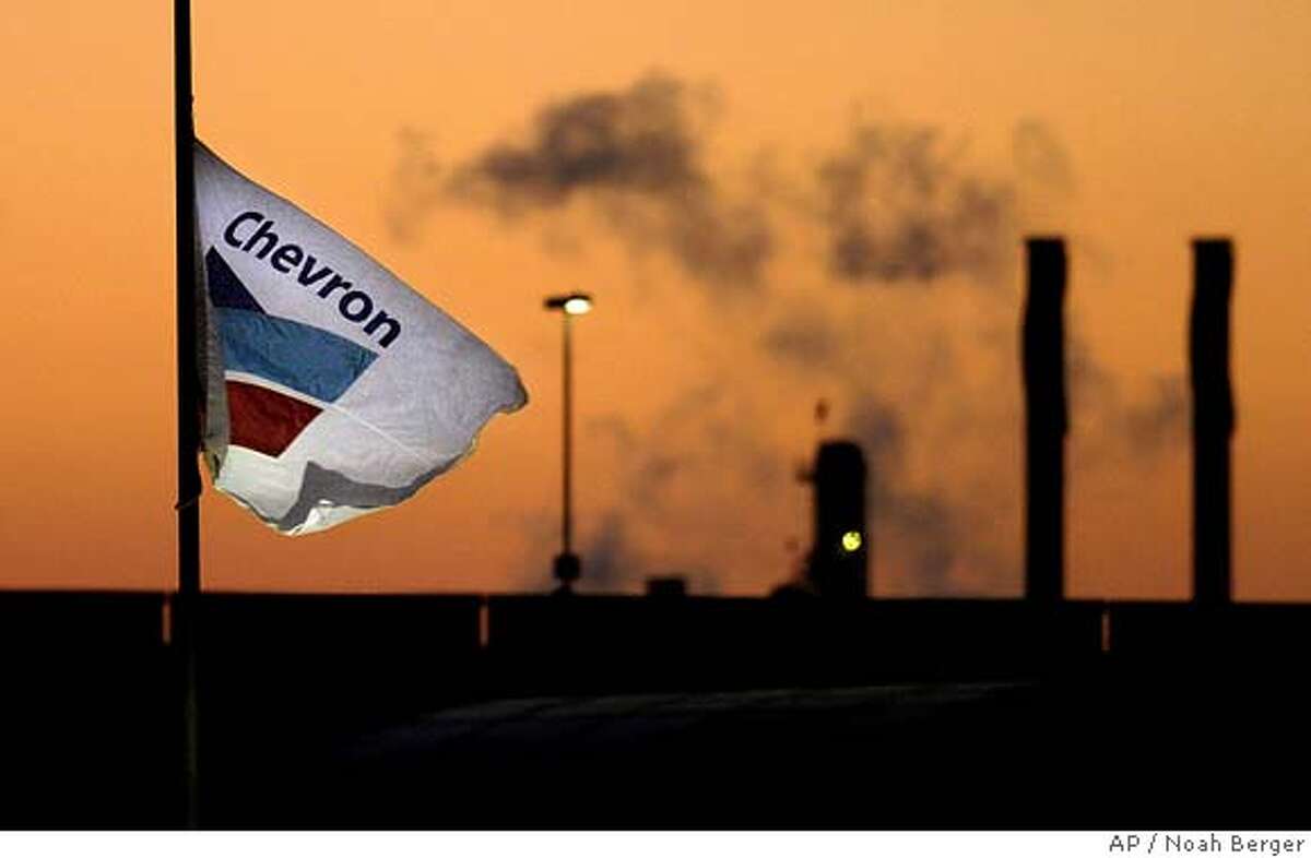 Smoke billows from a ChevronTexaco refinery in Richmond, Calif., on Tuesday, July 26, 2005. The stakes will be higher than usual Friday morning when Chevron Corp. discloses its second-quarter earnings _ the results could deliver a pivotal blow to the company's politically charged battle to buy Unocal Corp. The financial report for the three months ended in June will carry added punch because it's likely to influence the price of Chevron's stock, which is being used to pay for most of the company's Unocal bid, valued at $17.2 billion entering Thursday's trading. (AP Photo/Noah Berger) Ran on: 07-29-2005 Chevron, which owns this Richmond refinery, is trying to persuade Unocal shareholders to accept its bid for the company
