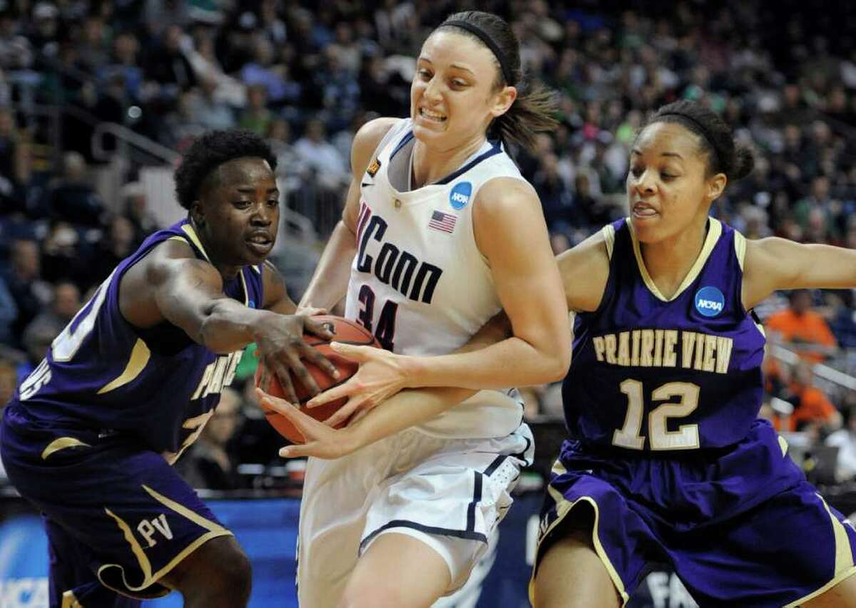Connecticut's Kelly Faris, center, is pressured by Prairie View A&M's JaQuandria Williams, left, and Michaela Burton, right, during the first half of an NCAA tournament first-round college basketball game in Bridgeport, Conn., Saturday, March 17, 2012. (AP Photo/Jessica Hill)