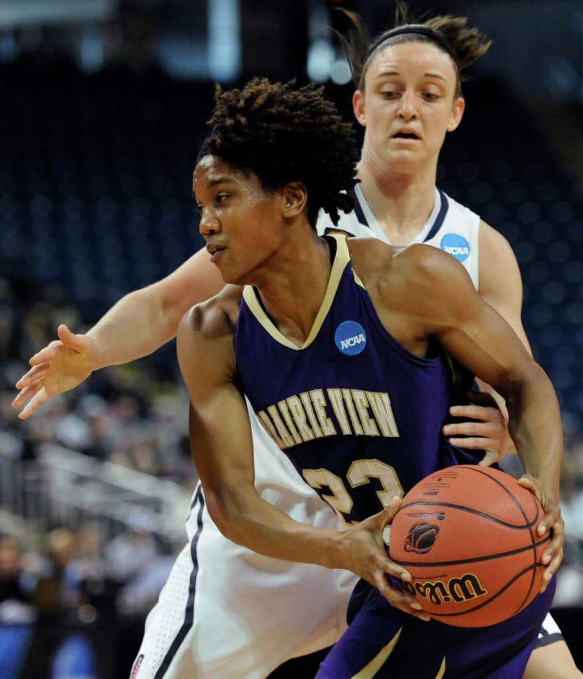 Prairie View A&M's Latia Williams, front, is guarded by Connecticut's Kelly Faris, back, during the first half of an NCAA tournament first-round college basketball game in Bridgeport, Conn., Saturday, March 17, 2012. (AP Photo/Jessica Hill)