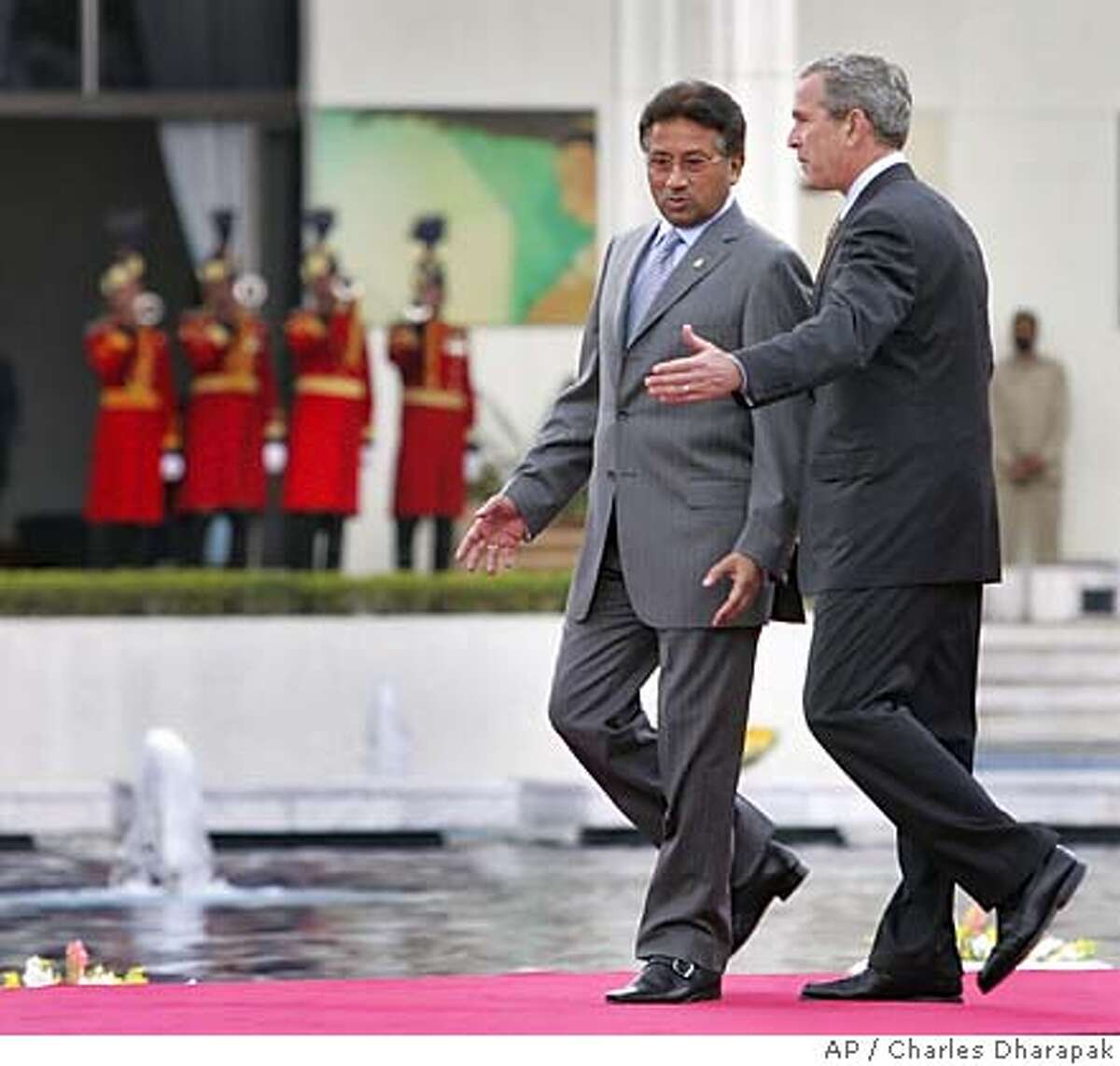 U.S. President George W. Bush, right, and Pakistani President Pervez Musharraf walk together to a joint press availability at Aiwan-e-Sadr, or "house of the President", in Islamabad, Pakistan, Saturday, March 4, 2006. President Bush showed solidarity Saturday with Pakistani President Gen. Perez Musharraf's war-on-terror alliance with the United States, a stance that is at odds with many in this Islamic nation. (AP Photo/Charles Dharapak)Ran on: 03-05-2006 President Bush and Pakistani President Pervez Musharraf walk to a joint news conference at the presidential palace in Islamabad.Ran on: 03-05-2006 President Bush and Pakistani President Pervez Musharraf walk to a joint news conference at the presidential palace in Islamabad.