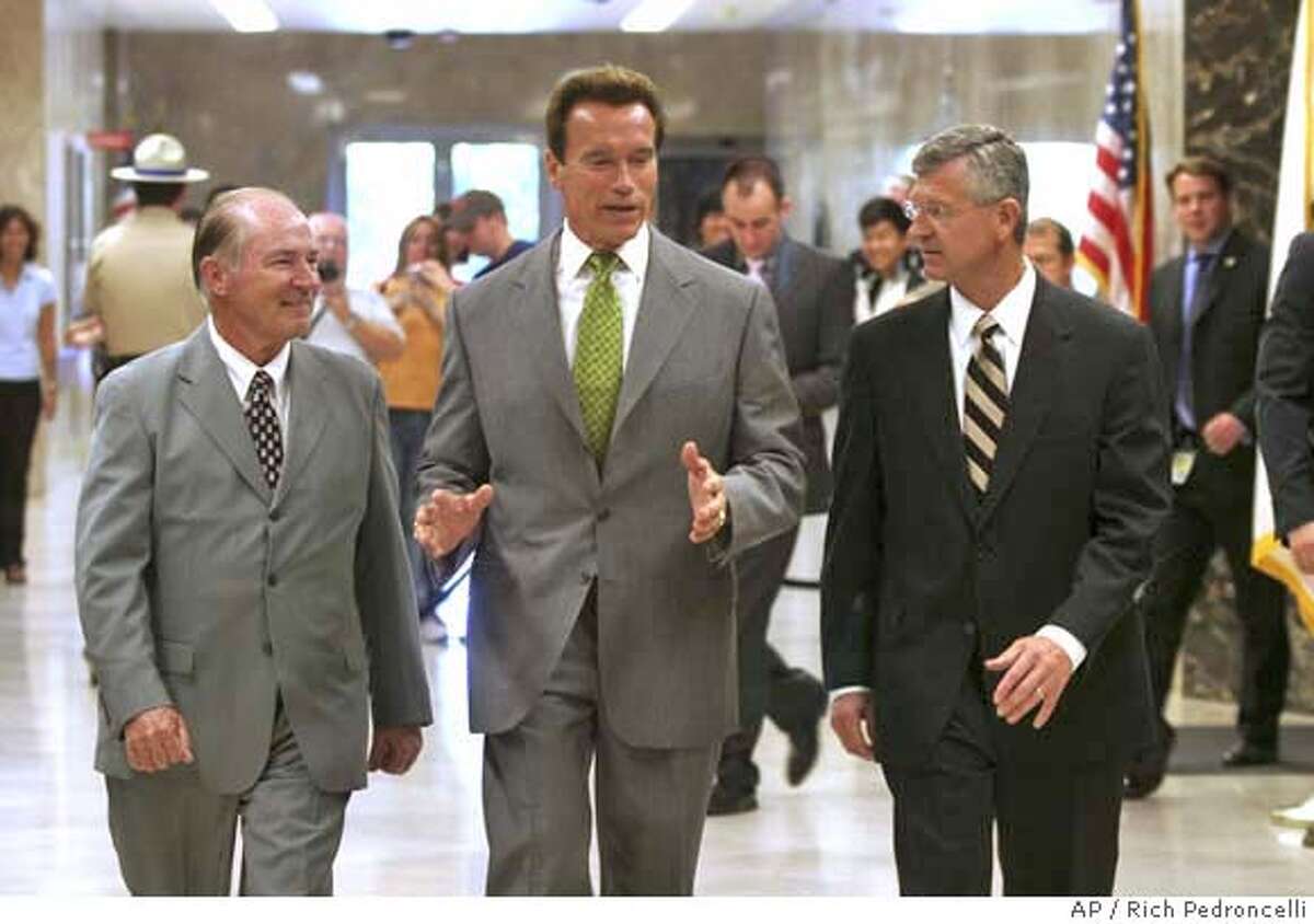 ** CORRECTS NAME TOEBBEN ** Gov. Arnold Scharzenegger, center, talks with Los Angeles Chamber of Commerce President and CEO Gary Toebben, right, and chairman of the board David Fleming, left, as they walk to a Capitol news conference Sacramento, Calif., Monday, Sept. 17, 2007. The pair announced the chamber's endorsement of Schwarzeneggers health care reform plan. While answering questions Schwarzenegger said he would veto a gay marriage bill approved by the legislature in the closing days of the legislative session. (AP Photo/Rich Pedroncelli) CORRECTS NAME TOEBBEN