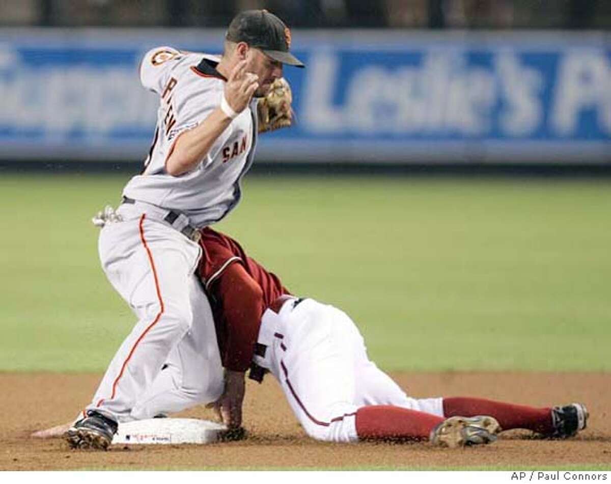 San Francisco Giants second baseman Kevin Frandsen, left, is run into by Arizona Diamondbacks' Eric Byrnes, right, after Byrnes was picked off during a steal attempt in the first inning of a baseball game Tuesday, Sept. 18, 2007, in Phoenix. (AP Photo/Paul Connors)