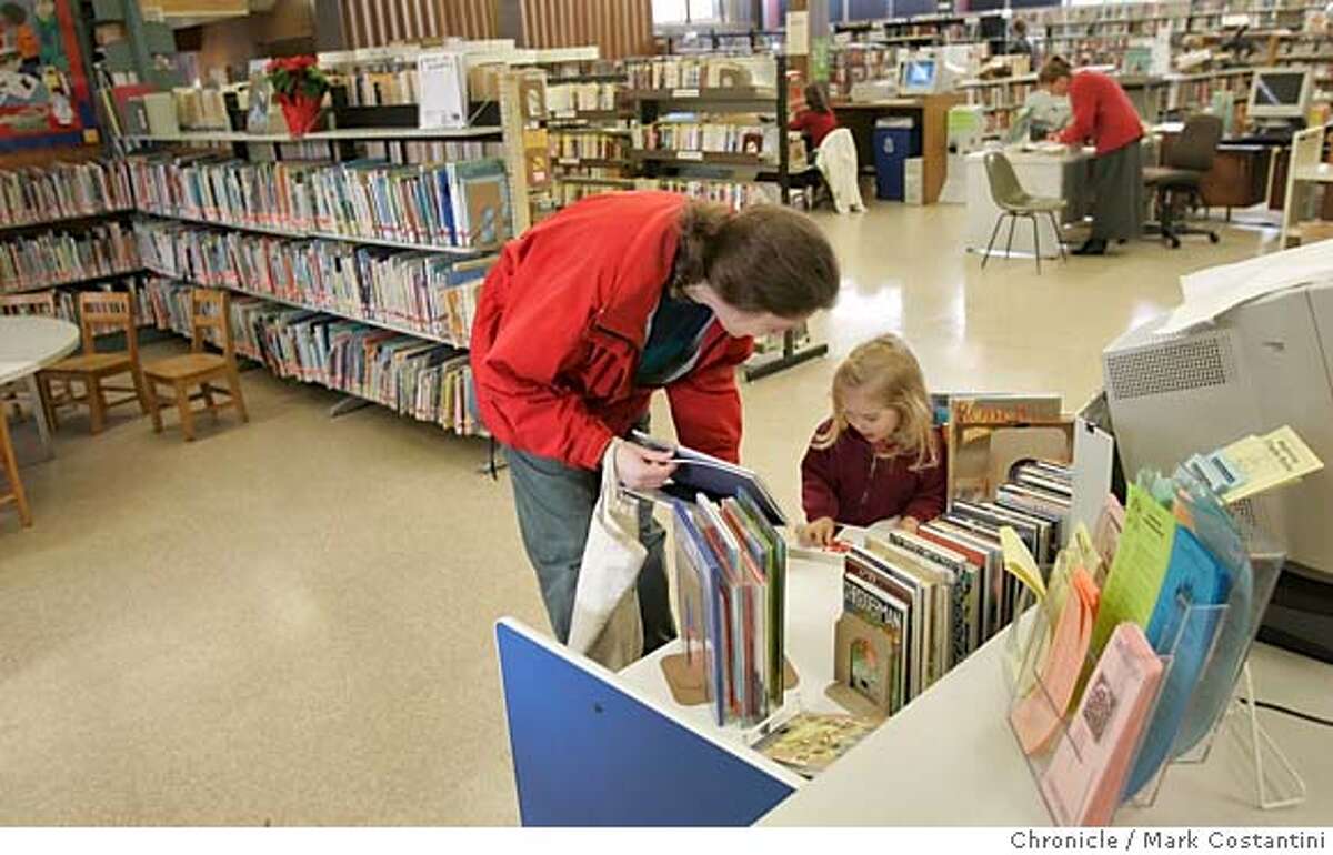 Rebecca Fisher and her daughter Alexandra Fisher, 2, Walnut Creek, look over children's books. Walnut Creek wants a big new library to replace the aging one in its upscale downtown. Please get a photo/photos of the current Walnut Creek library Event on 12/12/05 in Walnut Creek. Photo: Mark Costantini /San Francisco Chronicle.