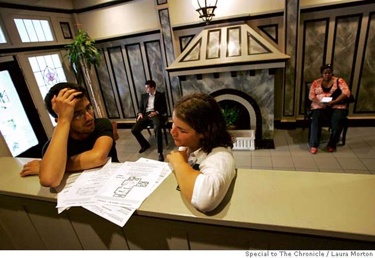 .jpg Denis Trotabas and Carolina Raga, who both recently moved to San Francisco from France, look over floor plans while waiting with several others to view an apartment for rent in Nob Hill during an open house. The San Francisco rental market has tightened up recently, making apartments harder to find. (Laura Morton/Special to the Chronicle) *** Denis Trotabas *** Caroline Raga