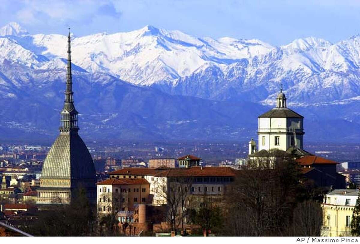 The Mole Antoneliana, left, The Italian city of Turin's most famous landmark is backdropped by the mountains, in Turin Monday Feb. 20, 2006. The Turin 2006 Winter Olympic Games are continuing in this historic northwestern Italian city. History has not always been kind to this rich outpost in northwest Italy. Hannibal came through and burned it to the ground. The French showed up several times, once led by Napoleon, and took the region for its own. Now it's held captive by all things Olympic. Streets are closed. Detours abound. Businesses near the skating oval are hurting. But the end is near. Though the Piedmont province is no stranger to be invaded, it also is no stranger to watching its captors come and go.(AP Photo/Massimo Pinca)