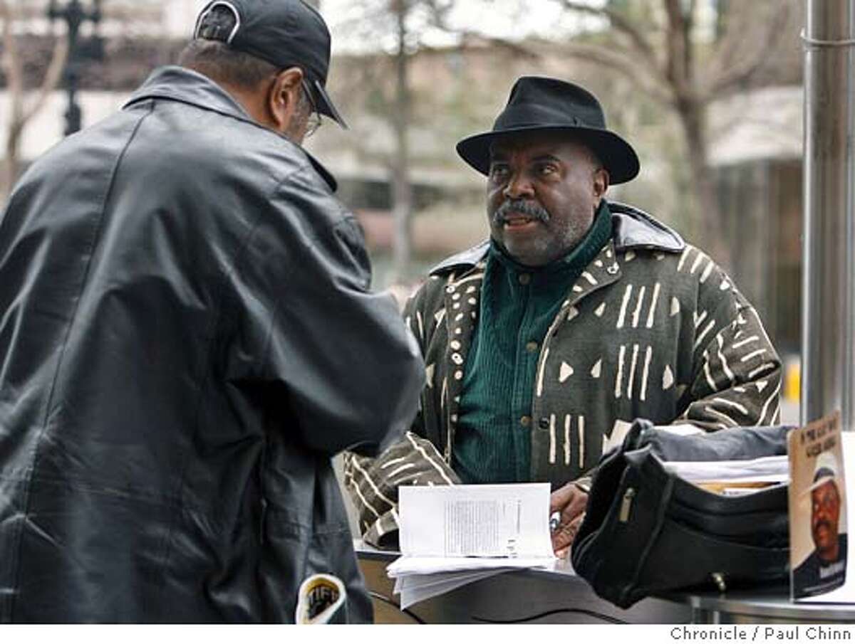 Author and arts activist Marvin X talks to Wilson Riles while selling his books along Broadway in downtown Oakland, Calif. on 2/17/06. He's a leader in the black arts movement and producer of the Tenderloin Book Fair and University of Poetry. PAUL CHINN/The Chronicle MANDATORY CREDIT FOR PHOTOG AND S.F. CHRONICLE/ - MAGS OUT