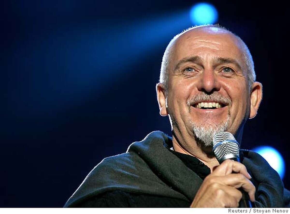 British musician Peter Gabriel smiles during the Africa Calling Live 8 concert, at the Eden Project in Cornwall, July 2, 2005. A galaxy of rock and roll stars will grace stages across the globe on Saturday for what is being billed as the greatest music show ever, in a bid to put pressure on leaders of the Group of Eight major industrialised nations meeting in Scotland next week to do more to alleviate poverty, particularly in Africa. Live 8, an expanded version of the Live Aid sensation 20 years ago, will take in 10 cities and four continents, kicking off in Tokyo in the east and ending in North America in the west. REUTERS/Stoyan Nenov 0