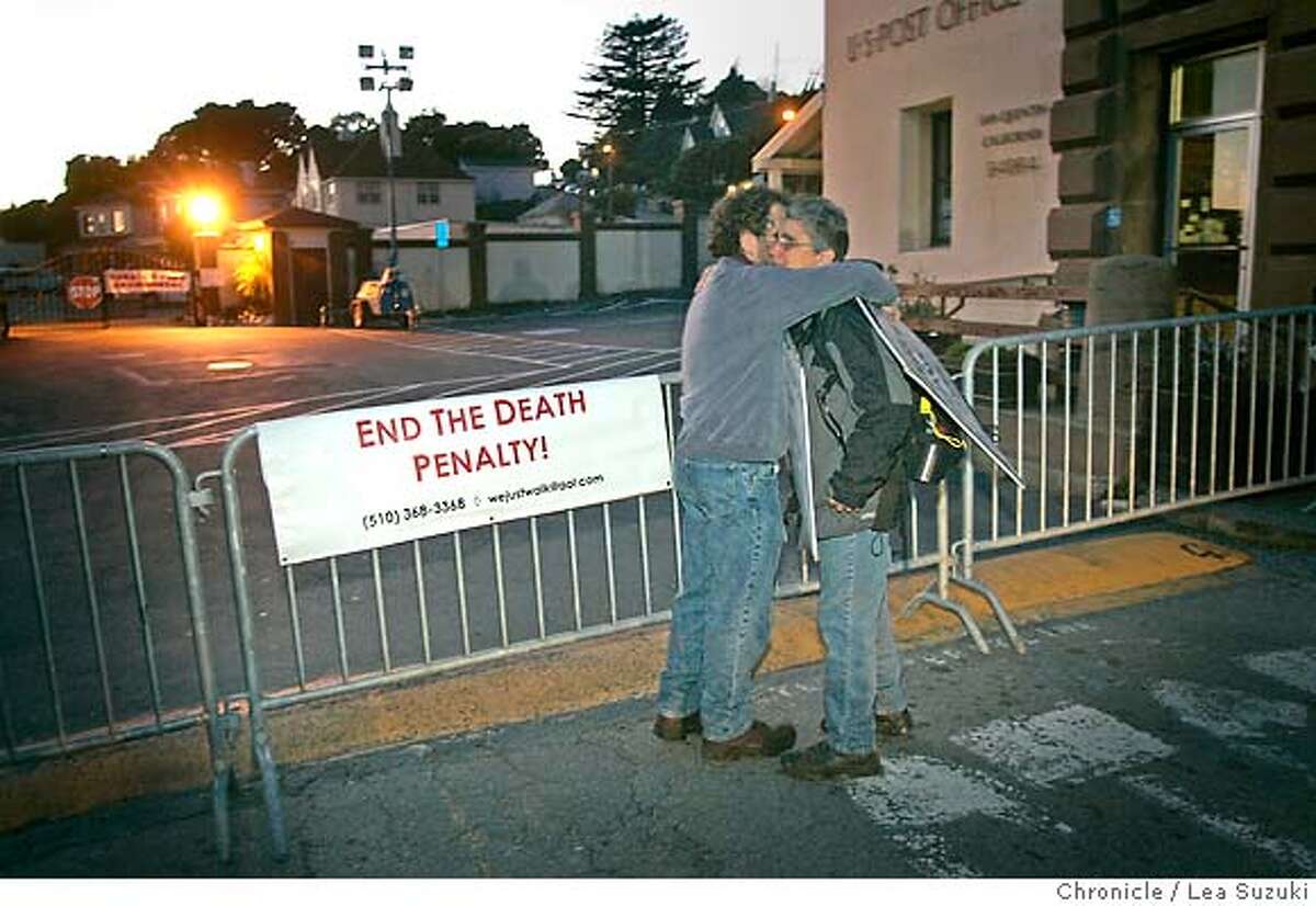 From left: Denis Paul of El Cerrito and Ruth Enero of Modesto embrace in front of the gate at San Quentin after walking from the Palace of Legion of Honor in San Francisco with a group that walks regularly on the day of an execution starting at 7am. Michael Morales is scheduled to be executed just after midnight. This assignment is for whatever crowds gather outside the prison. We're not planning a separate scener, but it's the only available live art for execution night. Photo taken on 2/20/06 in San Quentin, CA. Photo by Lea Suzuki/ The San Francisco Chronicle