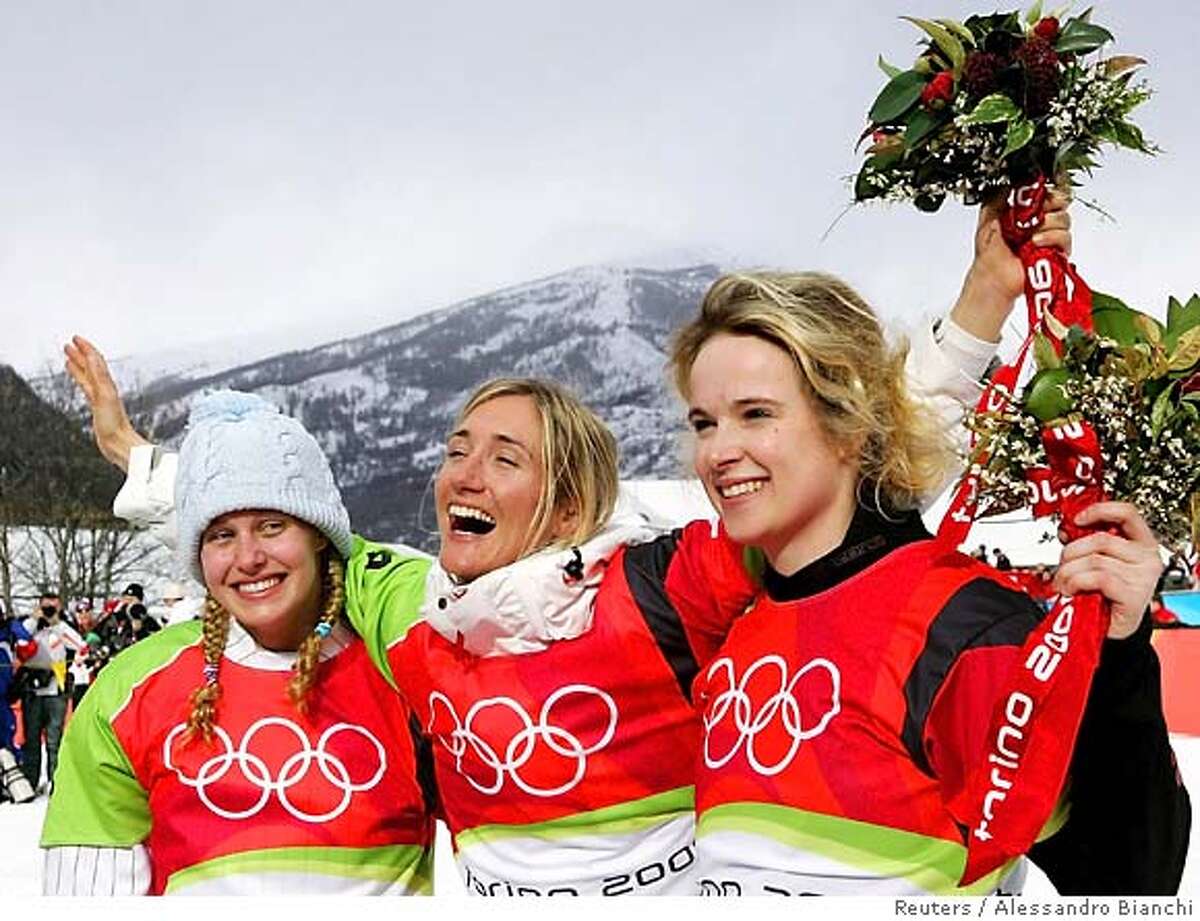 Switzerland's Tanja Frieden (C), Lindsey Jacobellis of the U.S. (L) and Canada's Dominique Maltais celebrate on the winners podium of the women's snowboard cross competition at the Torino 2006 Winter Olympic Games in Bardonecchia, Italy, February 17, 2006. REUTERS/Alessandro Bianchi