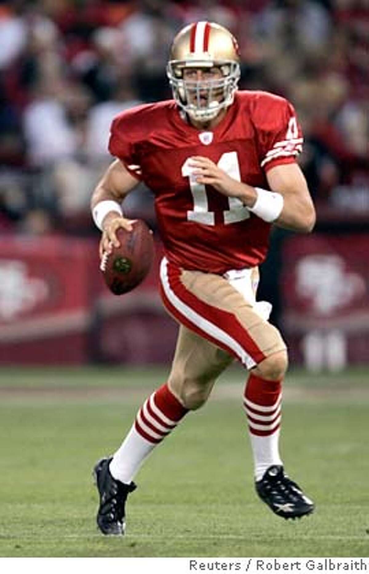 San Francisco 49ers quarterback Alex Smith rolls out to pass in the first quarter against the Arizona Cardinals during their NFL football game in San Francisco, California September 10, 2007. REUTERS/Robert Galbraith (UNITED STATES) 0