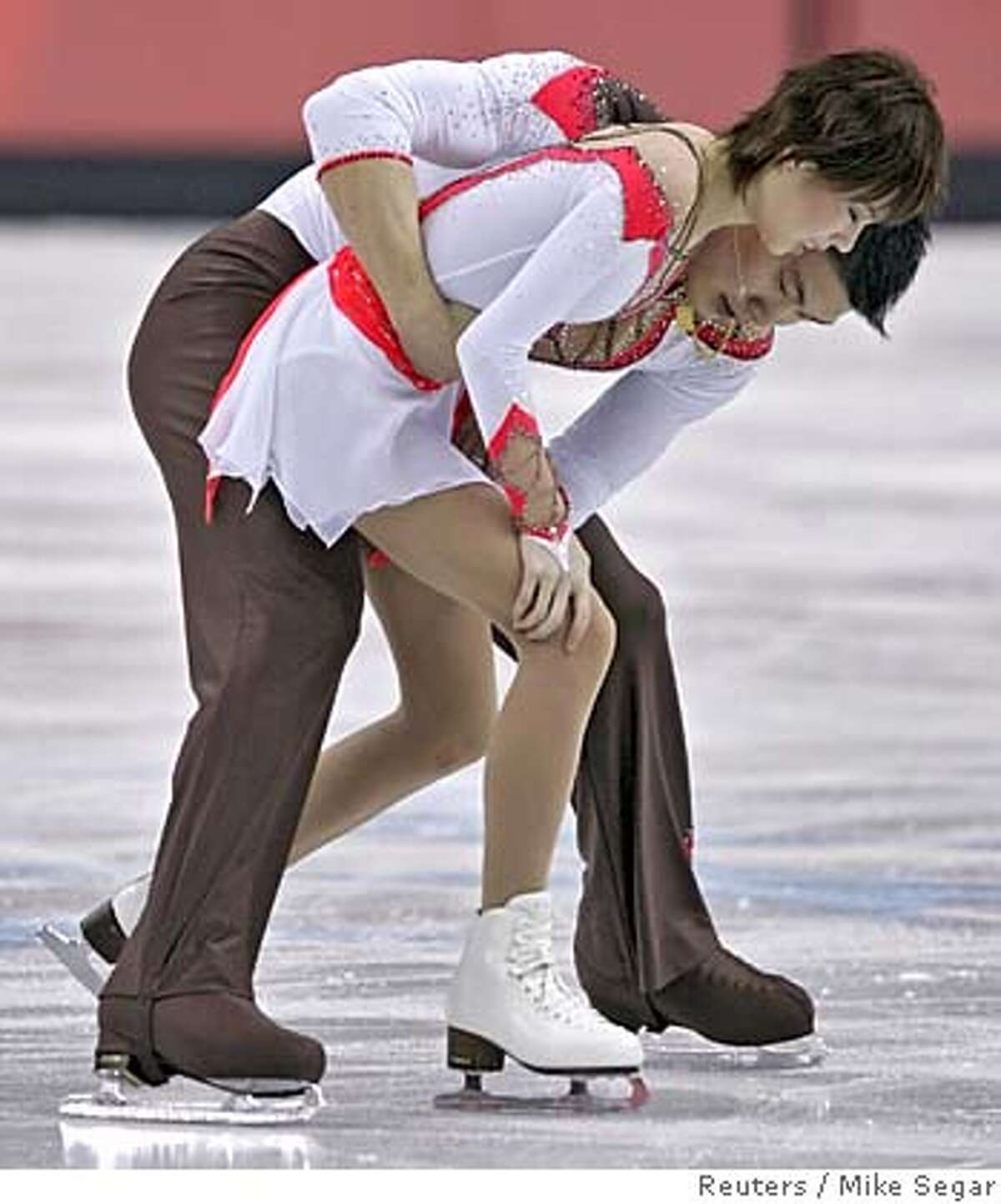 Zhang Dan hugs Zhang Hao from China after winning the silver medal in the figure skating Pairs Free Skating at the Torino 2006 Winter Olympic Games in Turin, Italy February 13, 2006. REUTERS/Mike Segar 0