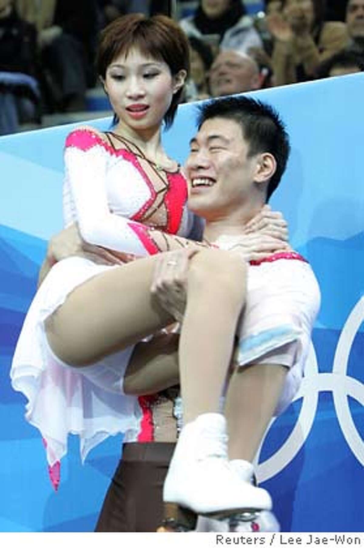 Zhang Dan is carried by Zhang Hao from China after winning the silver medal in figure skating Pairs Free Skating at the Torino 2006 Winter Olympic Games in Turin, Italy February 13, 2006. Dan fell and injured her leg. REUTERS/Lee Jae-Won 0