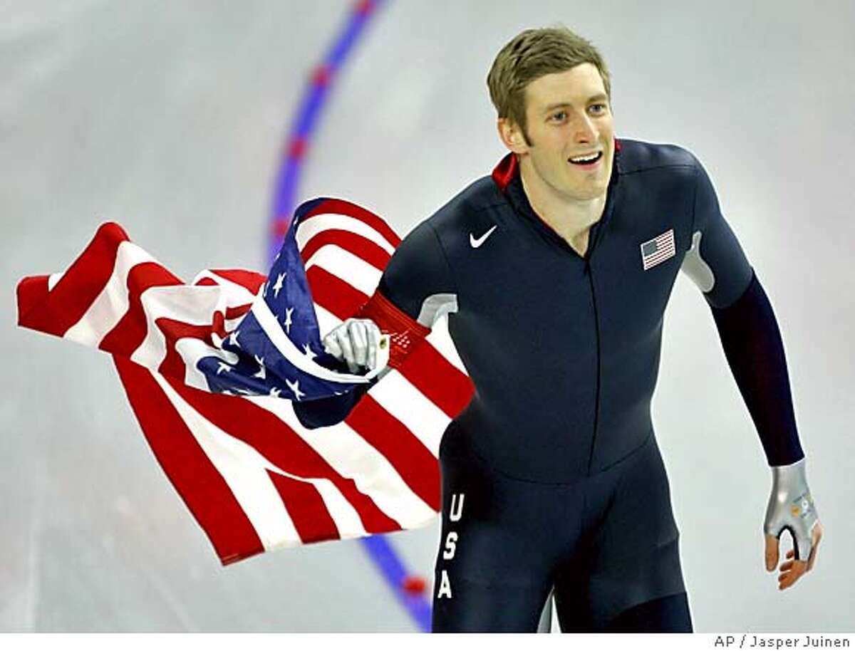 United States Joey Cheek, from Greensboro, N.C., holds an American national flag as he makes a victory lap during the Winter Olympics men's 500 meter speedskating sprint race at the Oval Lingotto in Turin, Italy, Monday, Feb. 13, 2006. Cheek won the gold medal in event. (AP Photo/Jasper Juinen)
