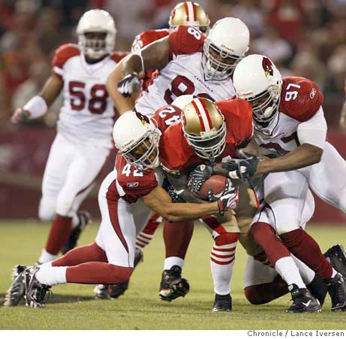 49ERS_CARDINALS_64589.JPG 49ers Frank Gore carries Arizona defenders as he makes a first down in second quarter action. San Francisco 49ers Vs. Arizona Cardinals. SEPT 10, 2007. Lance Iversen/The Chronicle (cq) SUBJECT 9/10/07,in SAN FRANCISCO. CA.