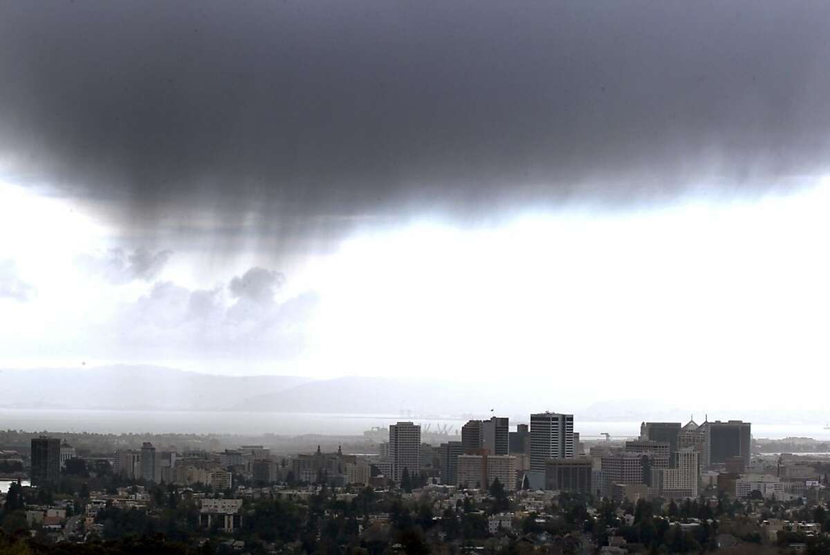 Storm clouds pass over downtown Oakland Saturday, March 17, 2012. The recent onslaught of storms has pushed the Bay Area up to about 50 percent of normal rainfall, and more wet weather is on the way.
