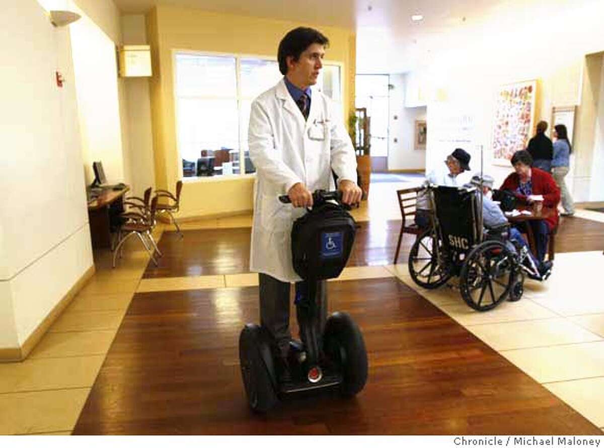 Dr. Peter D. Poullos travels the hallways of Stanford Hospital (where he works) on his battery powered Segway. Poullos was paralyzed in a cyciing accident leaving him to either use crutches or a wheelchair until he discovered the Segway. Photo taken on February 11, 2008 at Stanford, CA. Photo by Michael Maloney / The Chronicle MANDATORY CREDIT FOR PHOTOG AND SAN FRANCISCO CHRONICLE/NO SALES-MAGS OUT