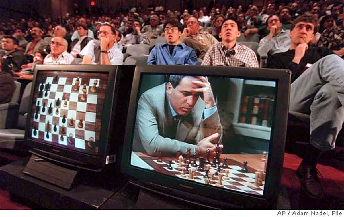 An audience watches as Garry Kasparov is shown on a television screen contemplating his next move against Deep Blue, IBM's chess playing computer, during the second game of their six game rematch, Sunday, May 4, 1997, in New York. It was Man 1, Machine 0, after world chess champion Kasparov won the first game of the rematch on Saturday. (AP Photo/Adam Nadel)