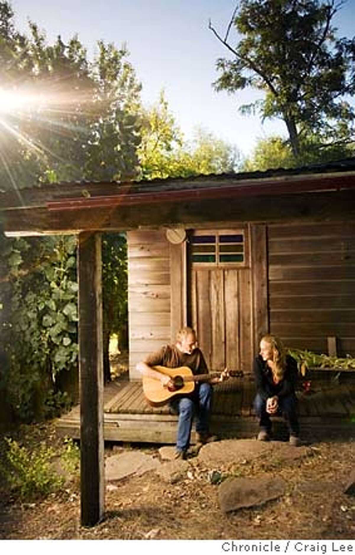 OTHERNAPA07_311_cl.jpg Story about Napa Valley wineries that have avoided the spotlight. Lore Olds and his daughter Mayacamus, owner of Sky Vineyards at the top of 2200 feet Mount Veeder. Photo of Lore (left) and Mayacamus (right), sitting and playing guitar on his front porch to the home he built in 1972 and where Mayacamus grew up. on 8/24/07 in Napa. photo by Craig Lee / The Chronicle Ran on: 09-02-2007 MANDATORY CREDIT FOR PHOTOG AND SF CHRONICLE/NO SALES-MAGS OUT