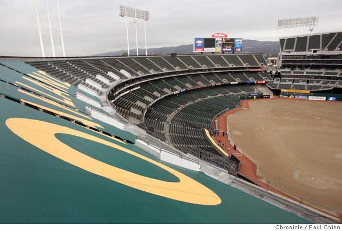 Team officials have already begun covering the third deck with tarps (foreground) which will reduce the ballpark's seating capacity this season. The annual Oakland A's Fanfest at McAfee Coliseum in Oakland, Calif. on 1/28/06. PAUL CHINN/The Chronicle MANDATORY CREDIT FOR PHOTOG AND S.F. CHRONICLE/ - MAGS OUT