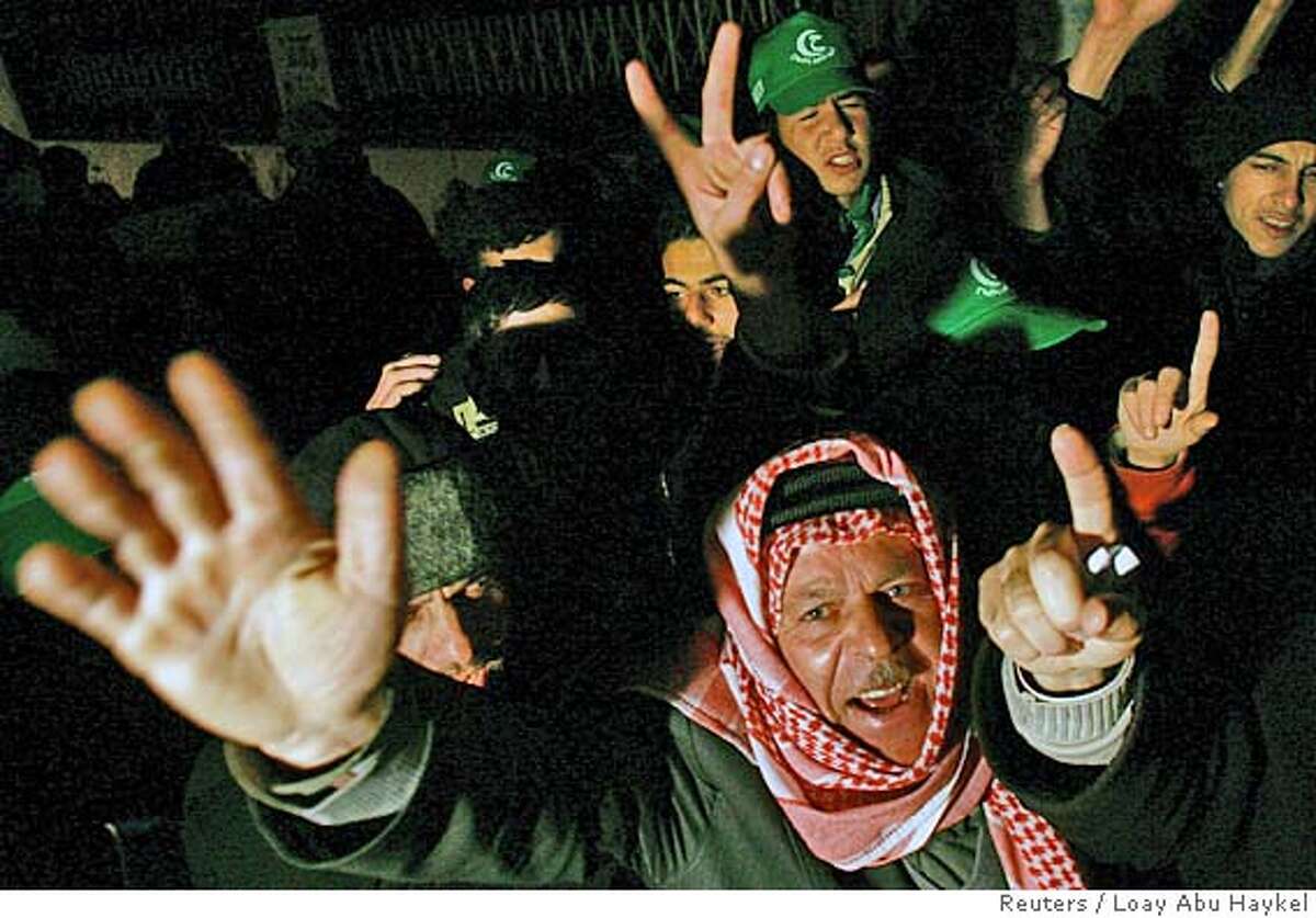 Supporters of Hamas gesture after polls closed in a Palestinian election in the West Bank city of Hebron January 25, 2006. Islamic militant group Hamas made a strong showing in the Palestinian parliamentary election on Wednesday, just a few percentage points behind the ruling Fatah movement, first projections showed. REUTERS/Loay Abu Haykel Ran on: 01-26-2006 Supporters of Hamas gesture after polls closed in the West Bank city of Hebron. This was the militant groups first campaign in a national election.