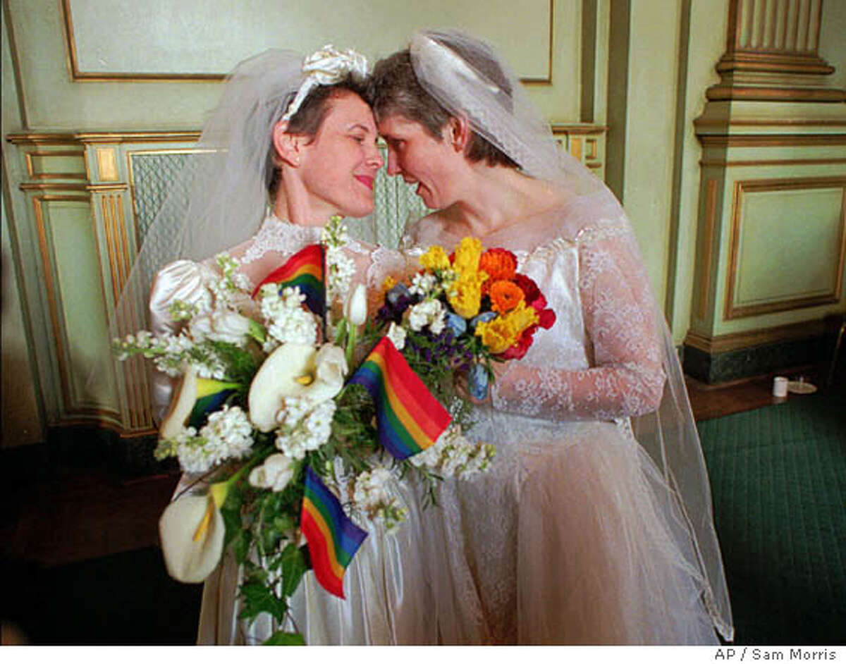 FILE--Jan Stafford, right, and Maxine Kincora, both wear wedding dresses before they were "married" in San Francisco Monday morning, March 25, 1996, under a new San Francisco ordinance. Although same-sex marriages are not legal in the state, dozens of gay and lesbian couples were united in a symbolic union. Many members of the gay and lesbian community feel betrayed by President Bill Clinton's decision to sign a GOP-sponsored bill that would bar federal benefits to same-sex couples even if a state legalized their union. (AP Photo/Sam Morris)