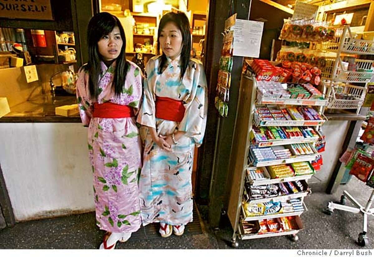 teagarden_0052_db.JPG Servers Mei Chiu, left, and Kelly Lam, wear colorful kimono style attire, standing next to snack stand, as they wait to serve customers tea and or cookies at the Japanese Tea Garden in Golden Gate Park. Event on 1/13/06 in San Francisco. Darryl Bush / The Chronicle MANDATORY CREDIT FOR PHOTOG AND SF CHRONICLE/ -MAGS OUT