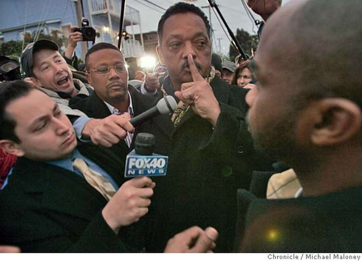 Outside the San Quentin gates, the Reverend Jesse Jackson signals to a heckler to be quiet after visiting Stanley Williams for the 2nd time. The vigil outside the gates to San Quentin Prison where Stanley "Tookie" Williams was to be executed shortly after midnight, Tuesday morning December 13, 2005. Pro and anti death penalty advocates were on hand to voice and demonstrate their views. Williams, once the leader of the Crypts gang was convicted and sentenced to death for 4 murders. The governor refused clemency for Williams Monday. Event in San Quentin, CA Photo by Michael Maloney / The Chronicle