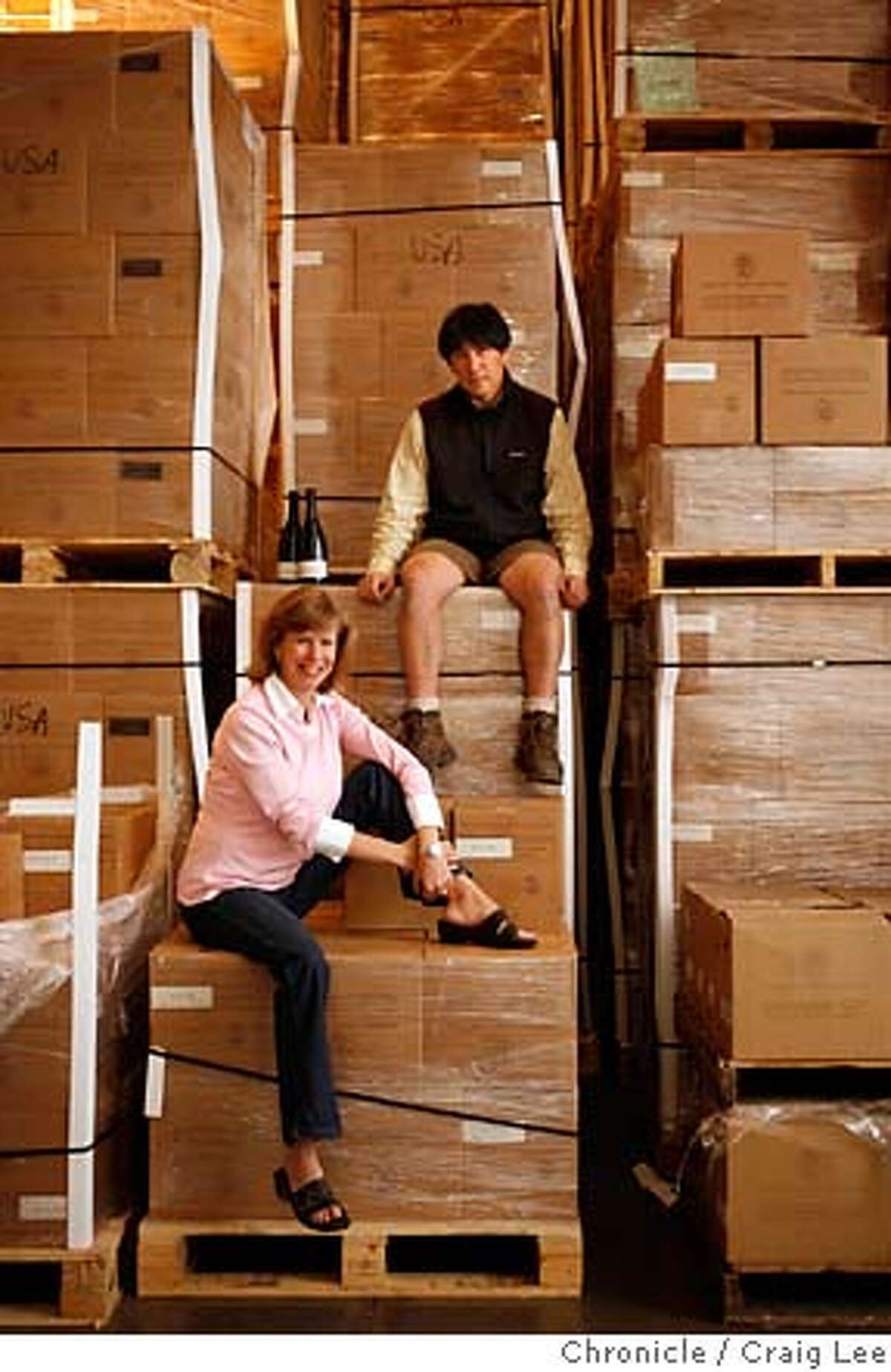 KINGSTON17_051_cl.JPG Story about Kingston Family Vineyards. Their wines and vineyard is in Chile and import their wines to the United States. Photo of Courtney Kingston (seated below) and Byron Kosuge (top), the winemaker. They are with almost all of their shipment of wine from Chile located in a warehouse in Napa. on 8/27/07 in Napa. photo by Craig Lee / The Chronicle MANDATORY CREDIT FOR PHOTOG AND SF CHRONICLE/NO SALES-MAGS OUT