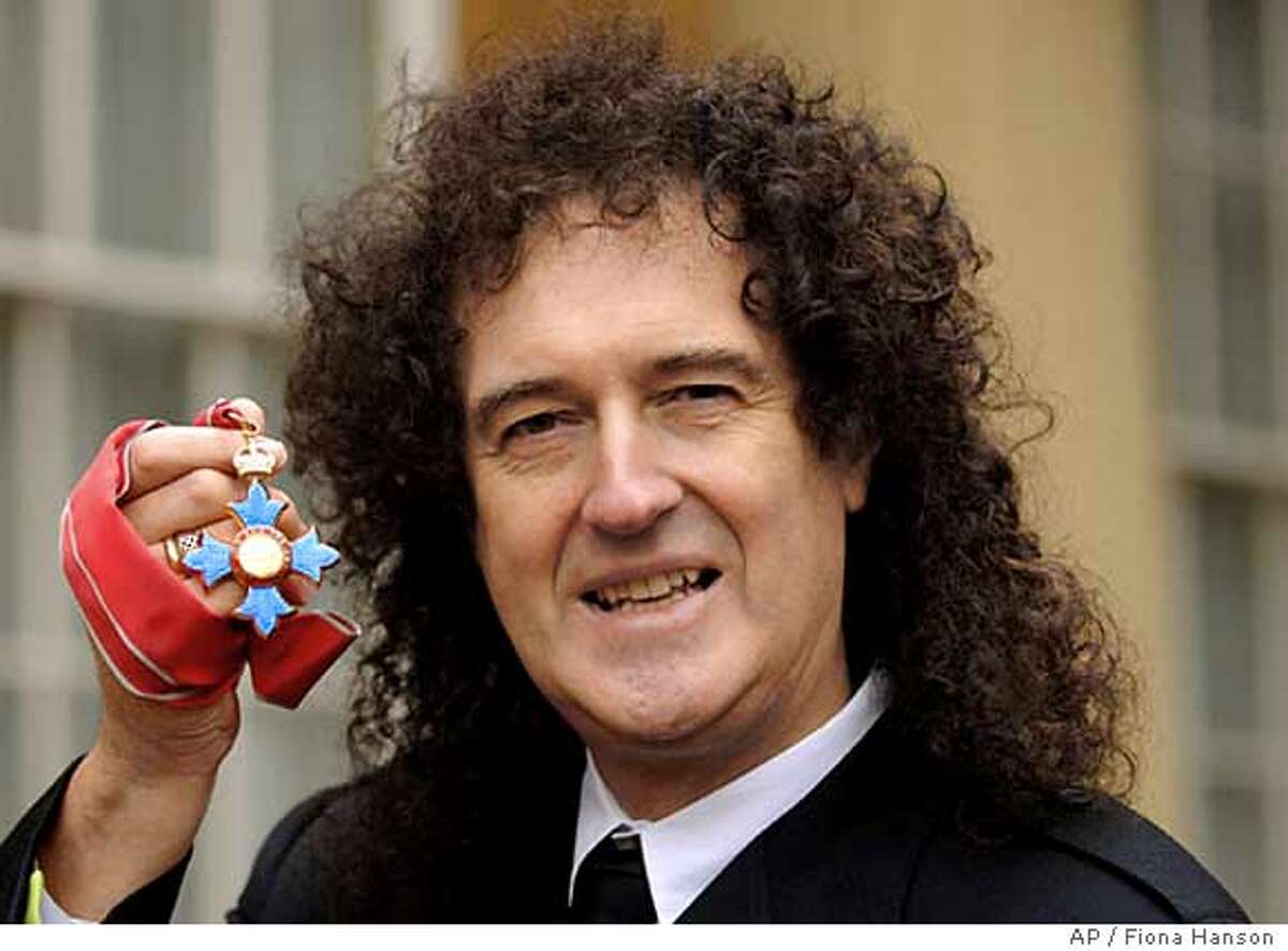 Queen guitarist Brian May hold the insignia of his Commander of the British Empite award, after collecting it from Britain's Queen Elizabeth II during an investiture ceremony at Buckingham Palace in London, Tuesday Dec. 6, 2005.(A_P Photo/Fiona Hanson, pool) POOL