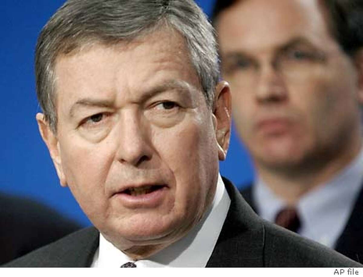Attorney General John Ashcroft, accompanied by United States Attorney for the Northern District of Illinois Patrick J. Fitzgerald, right, announces charges against Enaam Arnaout, head of a Chicago-area Islamic charity Wednesday, Oct. 9, 2002, in Chicago. Ashcroft vowed, "We will find the sources of terrorist blood money" as he announced the indictment of Arnaout on charges of funneling donations to Osama bin Laden's terrorist network. (AP Photo/M. Spencer Green)