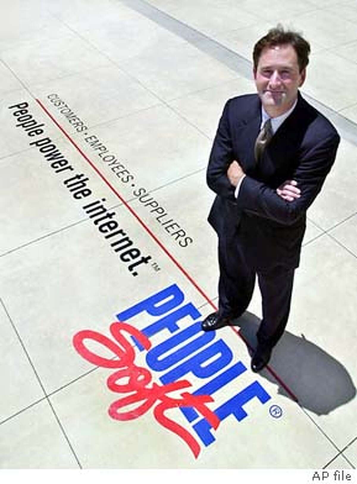 ** FILE ** Craig Conway, CEO of PeopleSoft, stands in front of his company's offices, Wednesday, June 28, 2000, in Pleasanton, Calif. On Friday, June 6, 2003, business software maker Oracle Corp. offered $5.1 billion to buy rival PeopleSoft Corp. in a hostile takeover attempt aimed at eliminating one of its fiercest competitors. The all-cash bid translates into $16 per share, just 6 percent above PeopleSoft's closing price of $15.11 before Oracle disclosed its plans. (AP Photo/Ben Margot) ALSO RAN 7/15/03 Craig Conway, PeopleSoft CEO and president. CAT