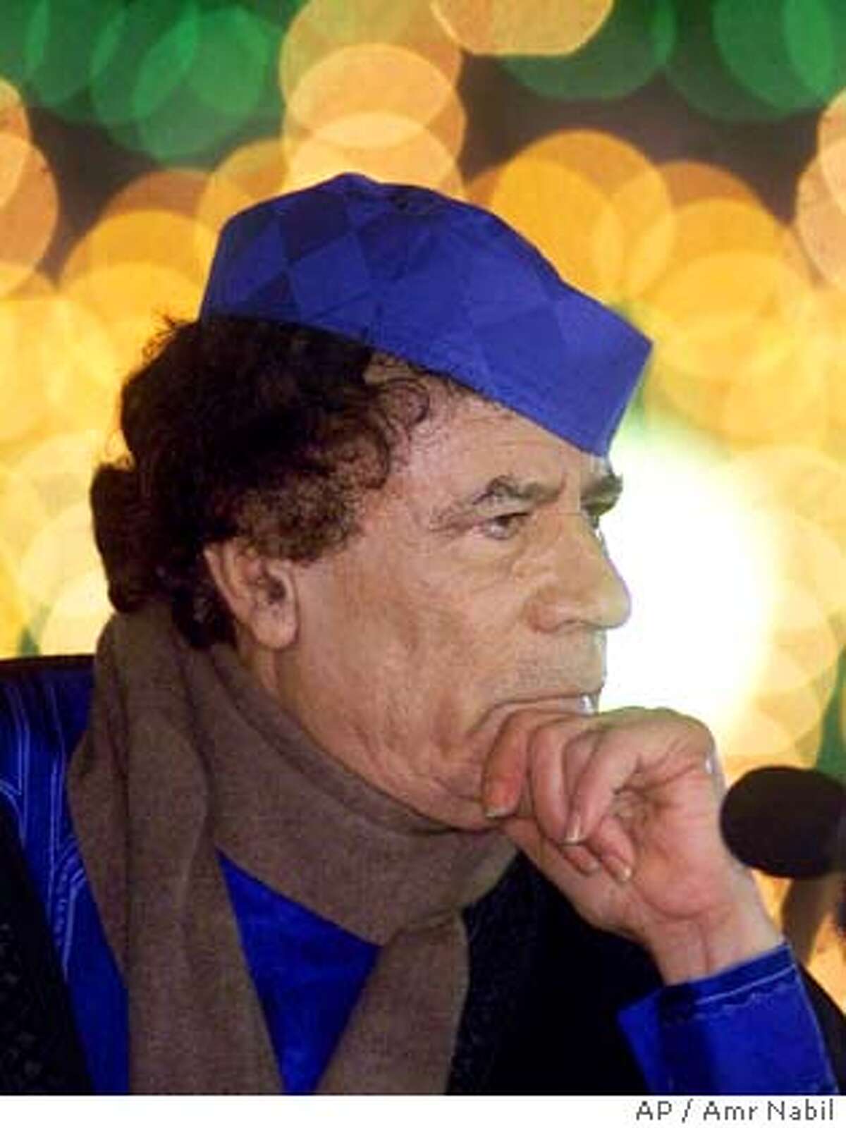 Libyan leader Moammar Gadhafi takes a question during a press conference in Triopli, Libya Monday, Feb. 5, 2001, in front of his home which was bombed by the U.S. Air Force on April 15, 1988. Gadhafi announced new evidence which he claims will prove that Libya is not involved in the 1988 Lockerbie bombing of Pan Am flight 103. A special Scpttich court in the Netherlands sentenced Abdel Basset Ali al-Megrahi to the minimum of 20 years in jail last week after finding him guilty in the attack. (AP Photo/Amr Nabil)