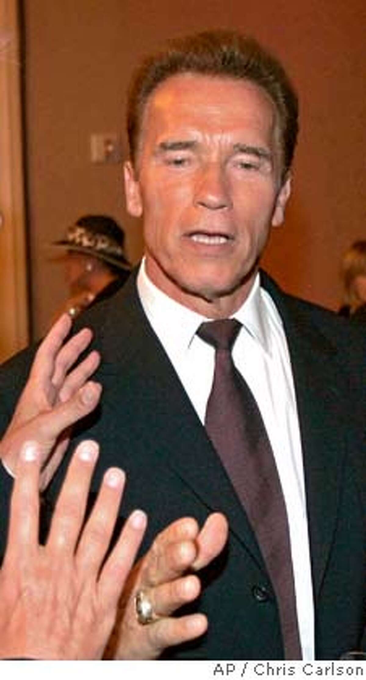 California Gov. Arnold Schwarzenegger talks with guests at a reception at the Beverly Hilton hotel after the funeral of entertainer and producer Merv Griffin in Beverly Hills, Calif., Friday, August 17, 2007. (AP Photo/Chris Carlson)