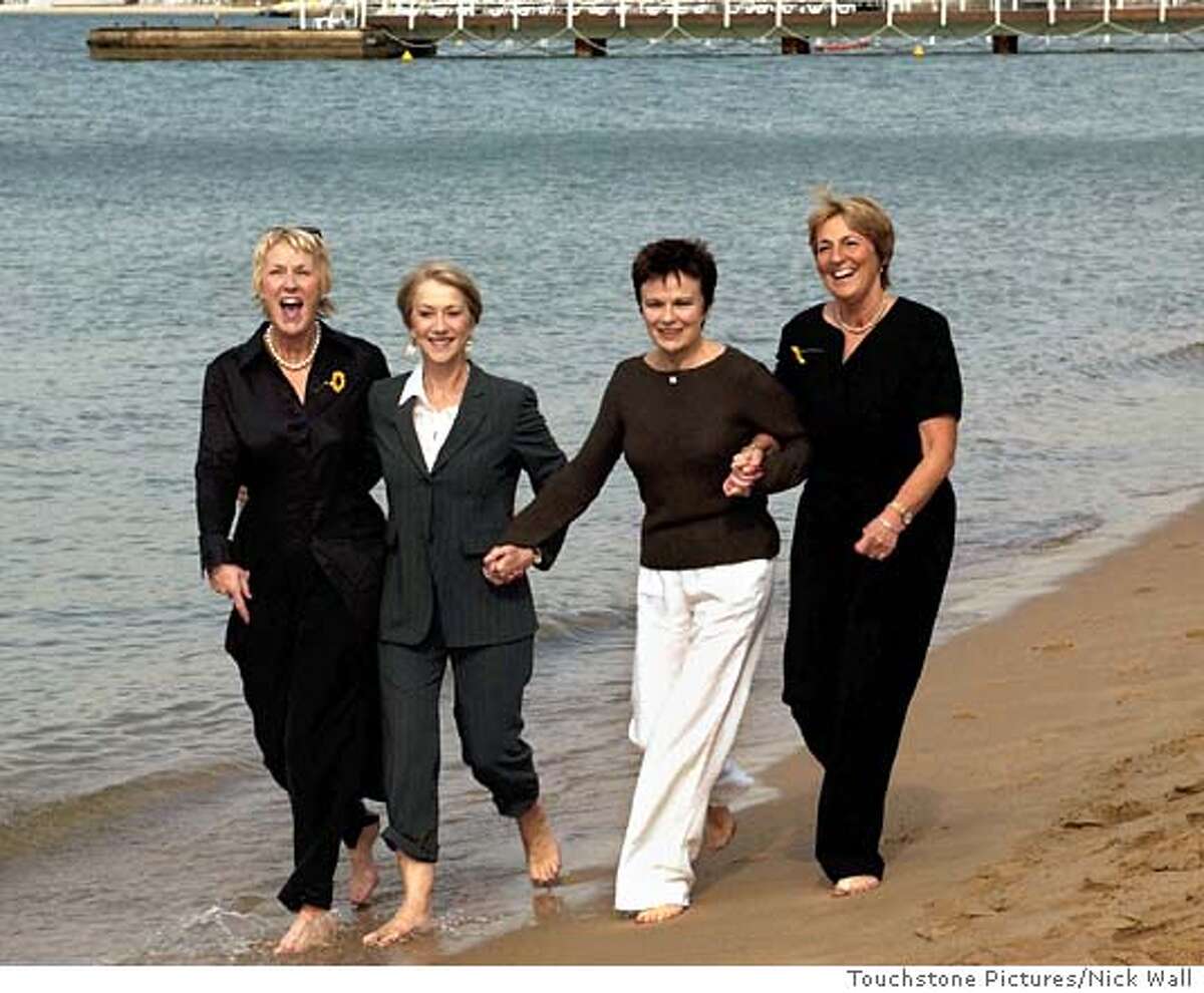 Actresses Helen Mirren, second left, and Julie Walters, second from right, walk along a beach with Trisha Stewart, far left, and Angela Baker, the real women who inspired their characters in Touchstone Pictures film "Calendar Girls," in this undated promotional photo. Coming Friday the film, is an ensemble comedy based on a real-life story of a group of British women in their 40s, 50s and 60s who posed naked for a calendar to raise charity money. (AP Photo/Touchstone Pictures, Nick Wall) UNDATED