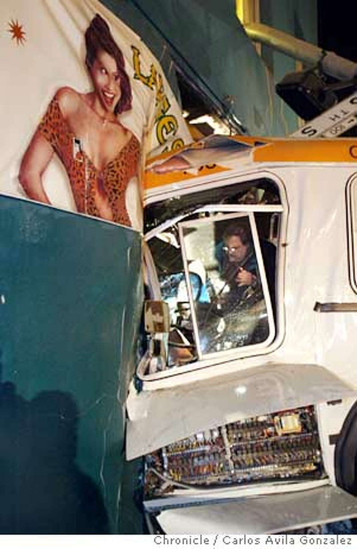 A muni bus drove into an adult bookstore on the corner of Mission and Sixth Street, causing some injuries but no deaths, Monday, Dec. 15, 2003. Chronicle Photo - Carlos Gonzalez