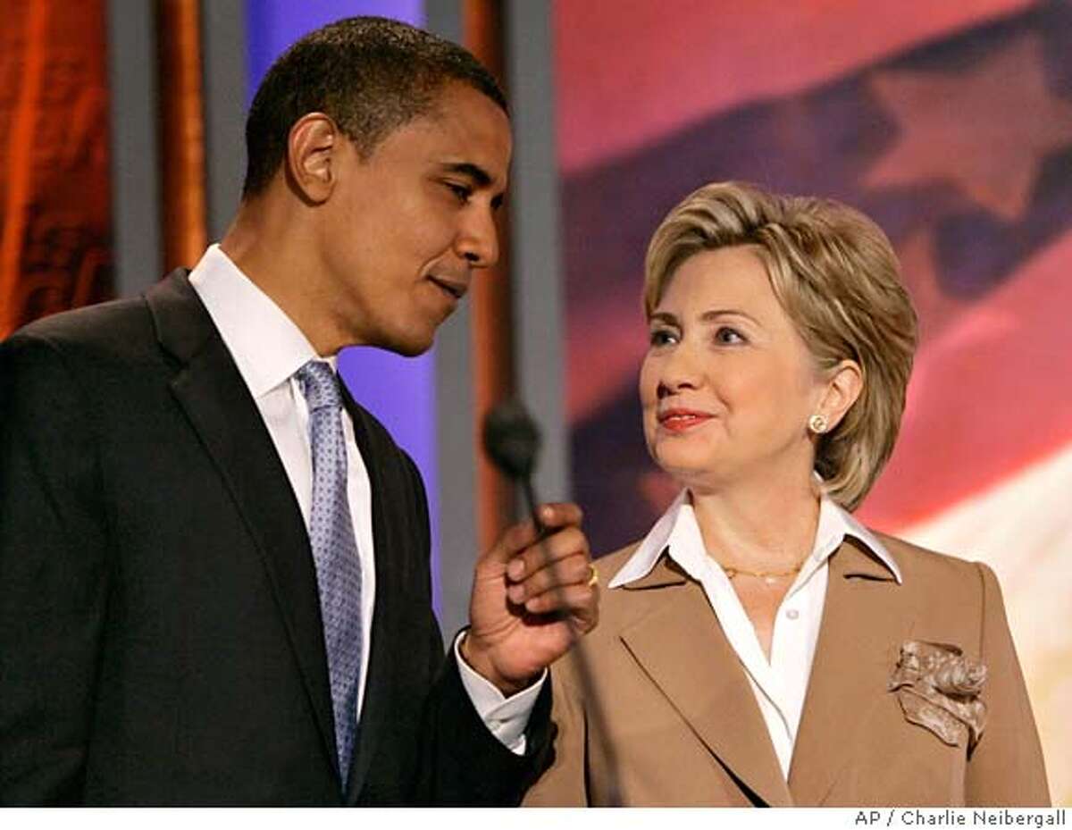 Democratic presidential hopefuls Sen. Barack Obama, D-Ill., and Sen. Hillary Rodham Clinton, D-N.Y., talk on stage during a break in the ABC News Democratic candidates debate, Sunday, Aug. 19, 2007, at Drake University in Des Moines, Iowa. (AP Photo/Charlie Neibergall)