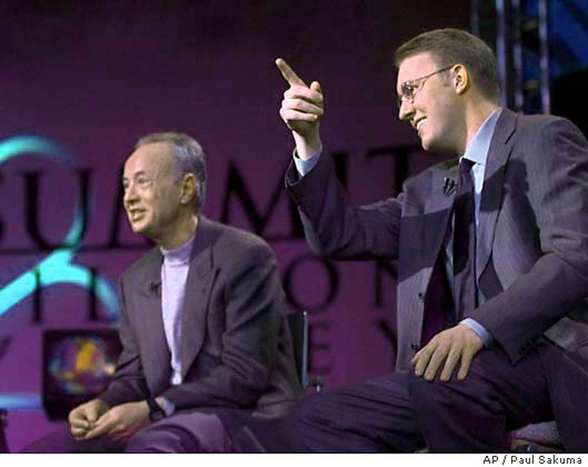 Marc Andreessen, right, chairman of Loudcloud and founder of Netscape, gestures in front of Intel Corp. founder and chairman Andy Grove, left, as they participate in a live broadcast of "Summit in Silicon Valley" that was put on by MSNBC in Stanford, Calif., Sunday, Feb. 27, 2000. (AP Photo/Paul Sakuma) CAT
