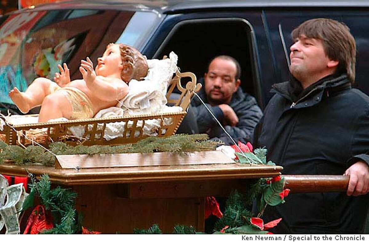 Christmas in Little Italy, New York City. "Baby" Jesus is pushed on a cart down Mulberry Street as a deliveryvan driver looks on. The faithful come up to the cart and pin dollar bills underneath him. Photo by Ken Newman/Special to the Chronicle. ONE TIME RIGHTS ONLY