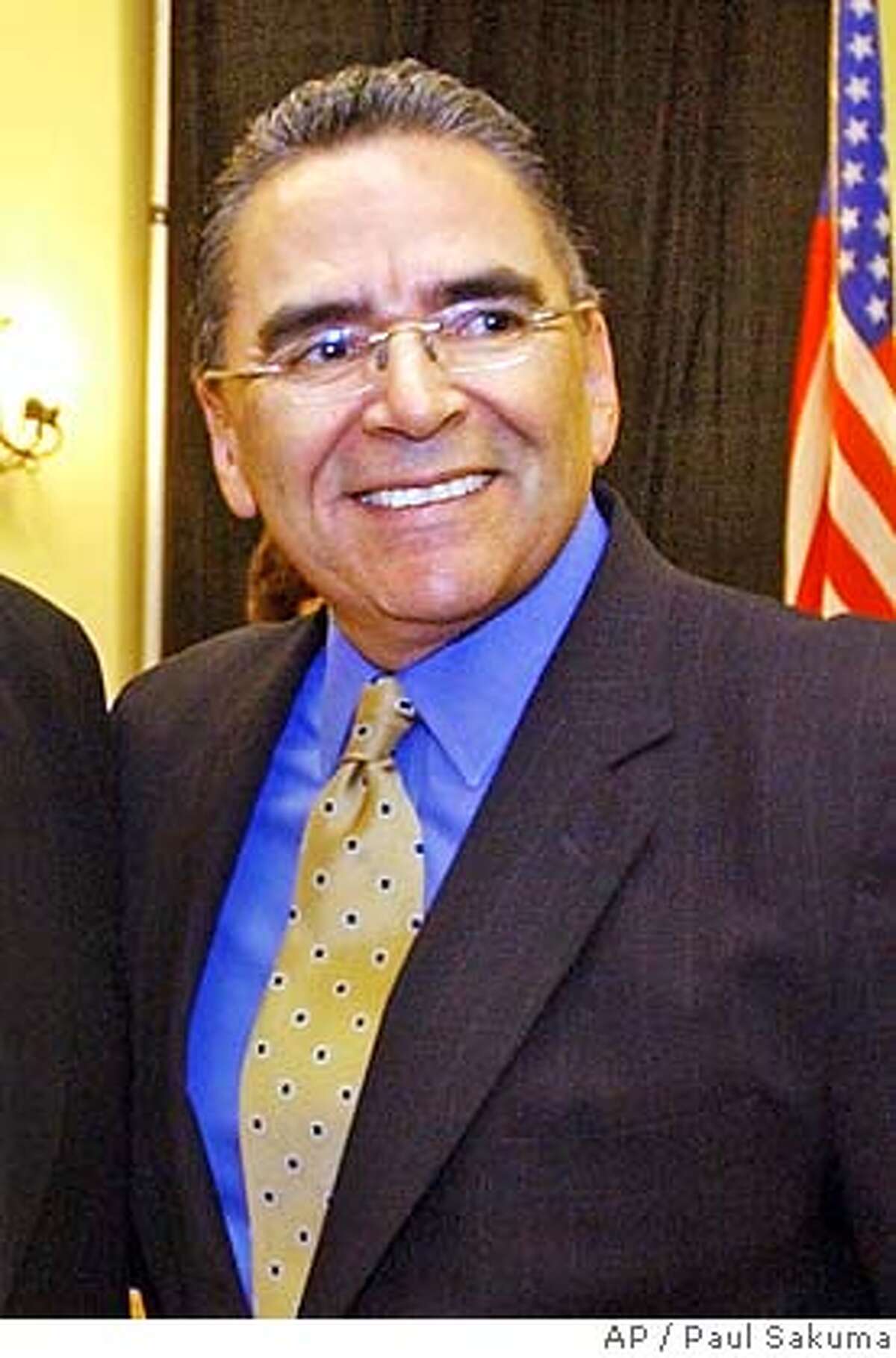 ** FILE ** San Jose Mayor Ron Gonzales smiles during a meeting with Silicon Valley business leaders in San Jose, Calif., Wednesday, April 14, 2004. A Santa Clara County judge dropped all criminal charges against Gonzales, who was accused of bribery in an alleged backroom deal with a trash-hauling company, court officials said Tuesday, June 11, 2007. While Superior Court Judge John Herlihy said Gonzales and his aide Joe Guerra improperly concealed their dealings with Norcal Waste Systems Inc., improper instructions given to the grand jury that indicted the pair required him to throw out the charges. (AP Photo/Paul Sakuma, file)