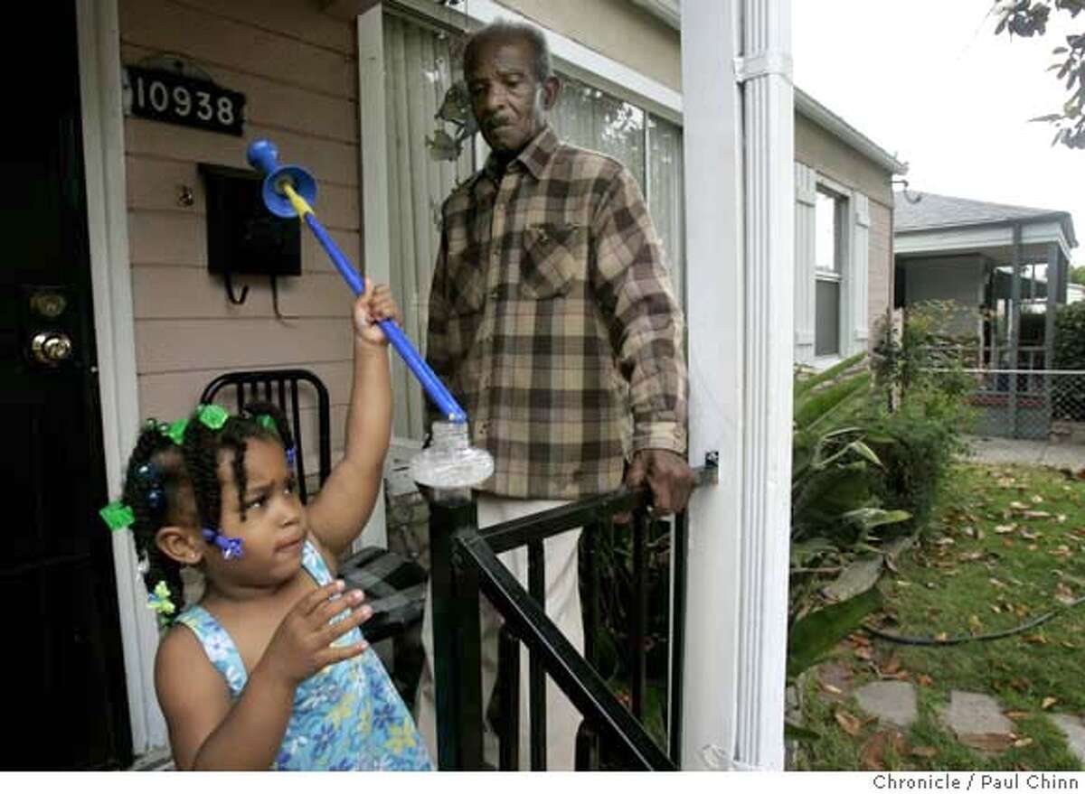 Johnnie Gardner watches his great niece Maaiah Bias play with a bubble wand on the front porch of his home in Oakland, Calif. on Tuesday, July 3, 2007. The Gardners face foreclosure on their home of 53 years after refinancing several times with a $4,000-a-month mortgage. JoAnn Gardner had to leave her job to care full-time for her elderly parents Johnnie and Estelle Gardner and can't afford to keep up with the payments. PAUL CHINN/The Chronicle **JoAnn Gardner, Johnnie Gardner, Estelle Gardner, Maaiah Bias MANDATORY CREDIT FOR PHOTOGRAPHER AND S.F. CHRONICLE/NO SALES - MAGS OUT