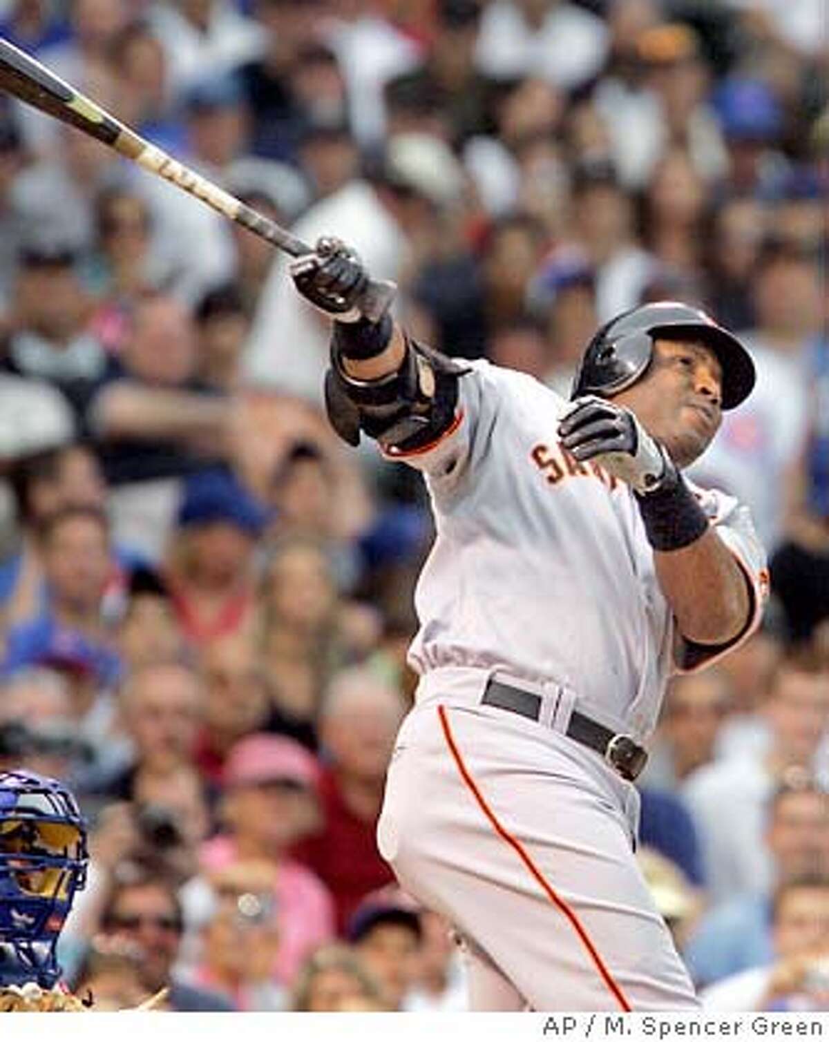 San Francisco Giants' Barry Bonds flips his bat after hitting a