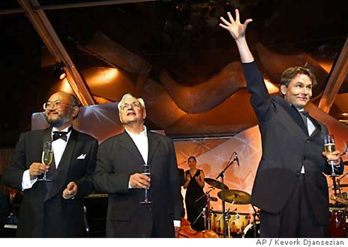 Los Angeles Philharmonic Music Director Esa-Pekka Salonen, right, acoustician Yasuhisa Toyota, left, and building architect Frank Gehry celebrate at a gala dinner following a grand opening concert at the new Walt Disney Concert Hall in Los Angeles, Thursday, Oct. 23, 2003. (AP Photo/Kevork Djansezian)