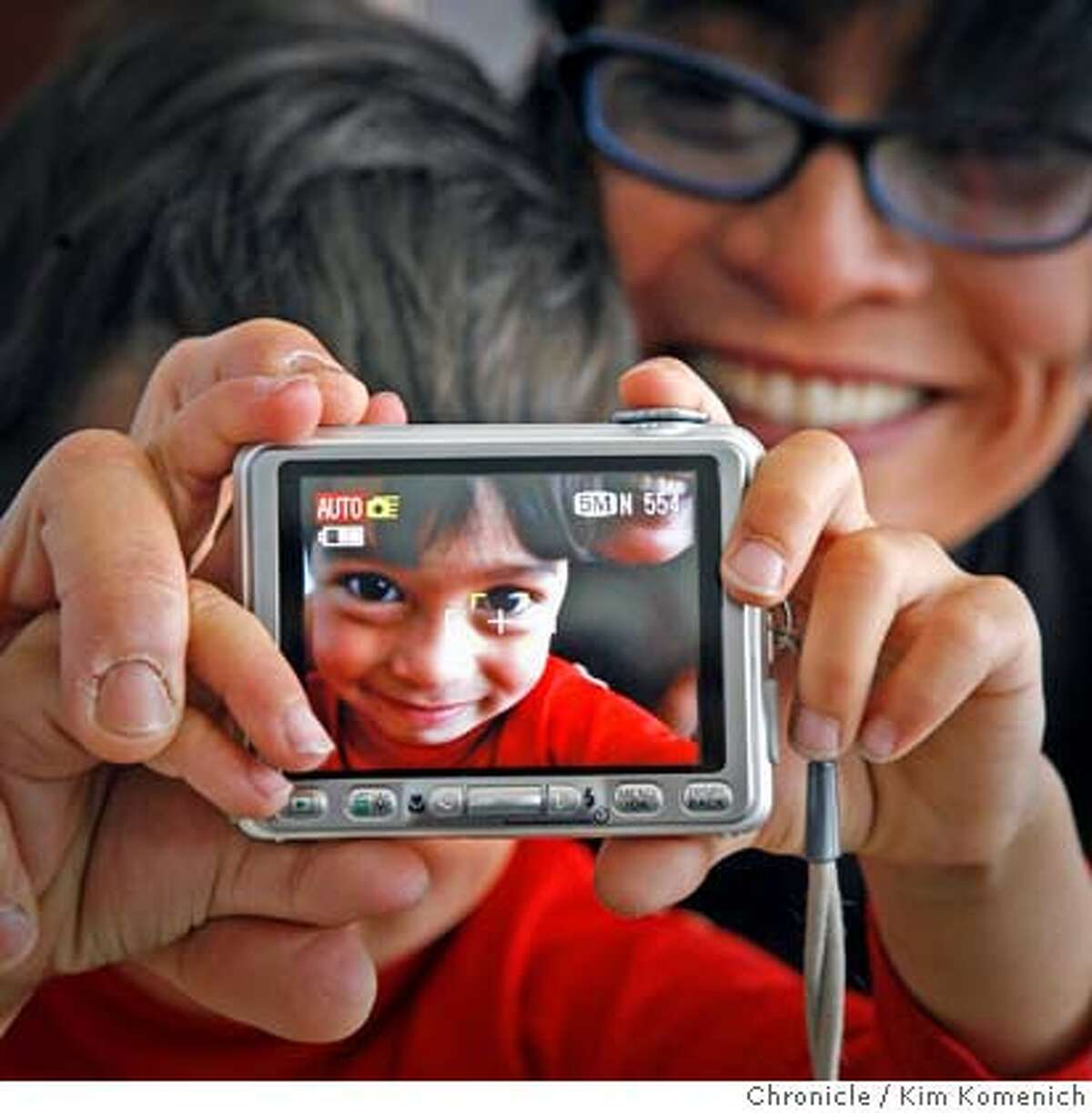 DIGITAL16_011_KK.JPG Sebastien Bachar (cq both), age 4, takes uses his digital camera as his mother J.D. Beltran holds him. Beltran is a multi-media artist, photographer and SF Art Institute professor. She is one of the people quoted in a Guthmann piece about the impact of digital photography on the personal lives of casual users and on the professional lives of fine-art and commercial photographers. Photo by Kim Komenich/The Chronicle J.D. Beltran, Sebastien Bachar MANDATORY CREDIT FOR PHOTOG AND SAN FRANCISCO CHRONICLE. NO SALES- MAGS OUT.