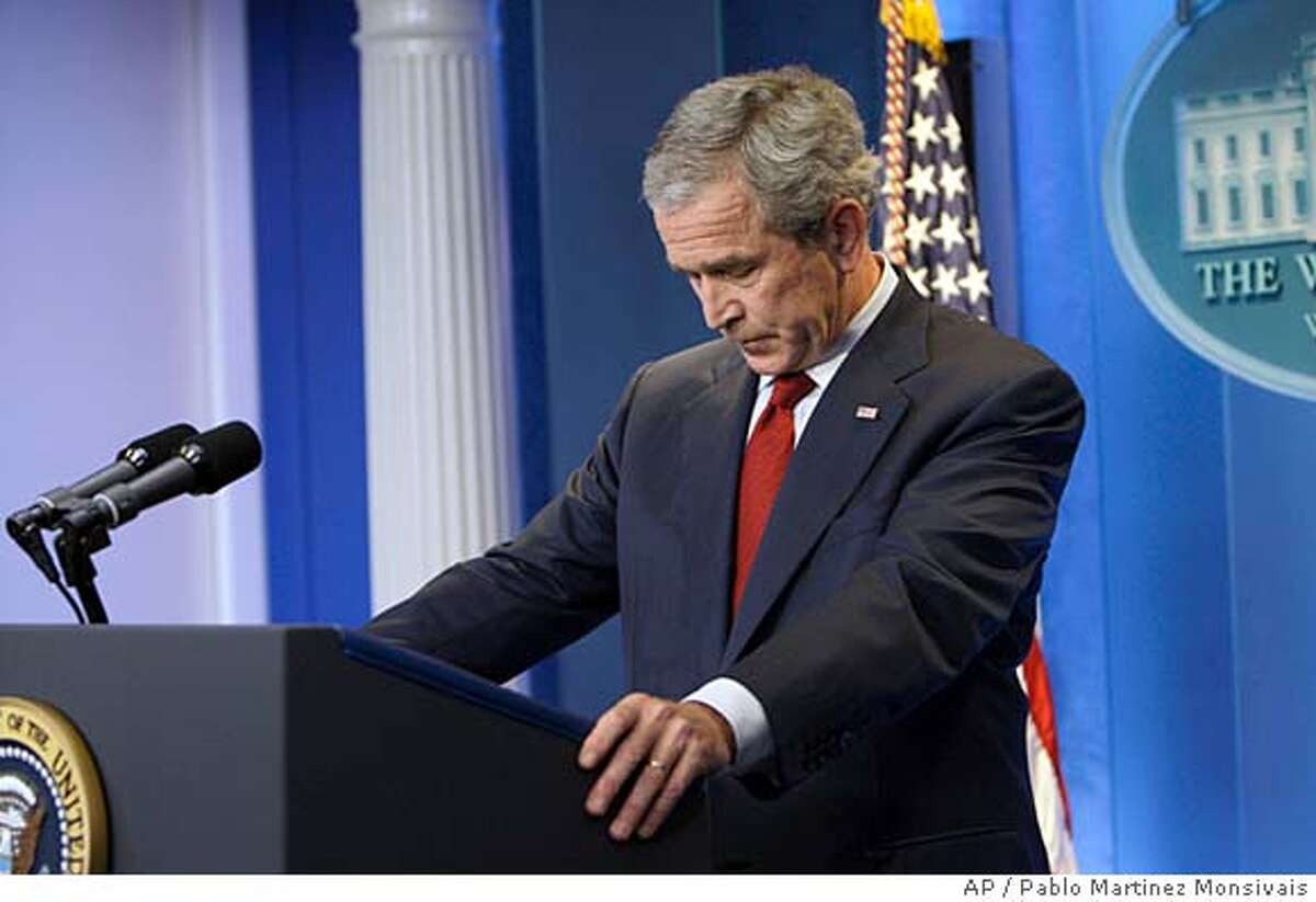 President Bush lowers his head as he prepares to answers questions during his press conference in the Brady Briefing Room, Thursday, July 12, 2007, at the White House in Washington. (AP Photo/Pablo Martinez Monsivais)