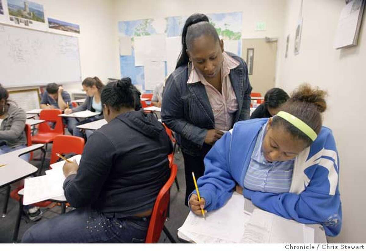 In this file photo Tahira Hodge (standing at center), a counselor at University Preparatory Charter Academy, (UPREP) monitors students as they take the STAR (Standardized Testing and Reporting) test in Oakland.