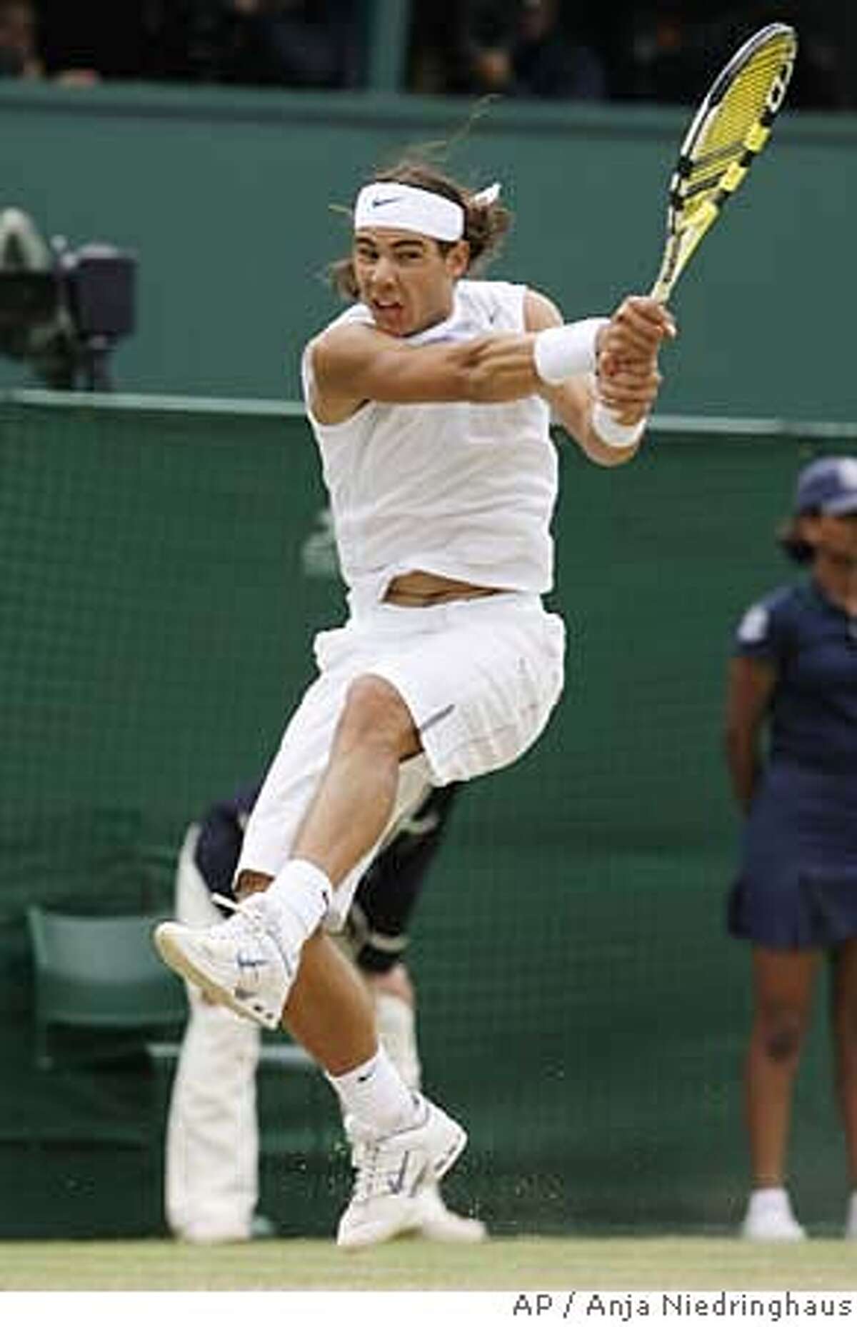 Spain's Rafael Nadal returns to Tomas Berdych of the Czech Republic, during their Men's Singles quarter final on the Centre Court at Wimbledon, Friday July 6, 2007. (AP Photo/Anja Niedringhaus) ** EDITORIAL USE ONLY ** EDITORIAL USE ONLY
